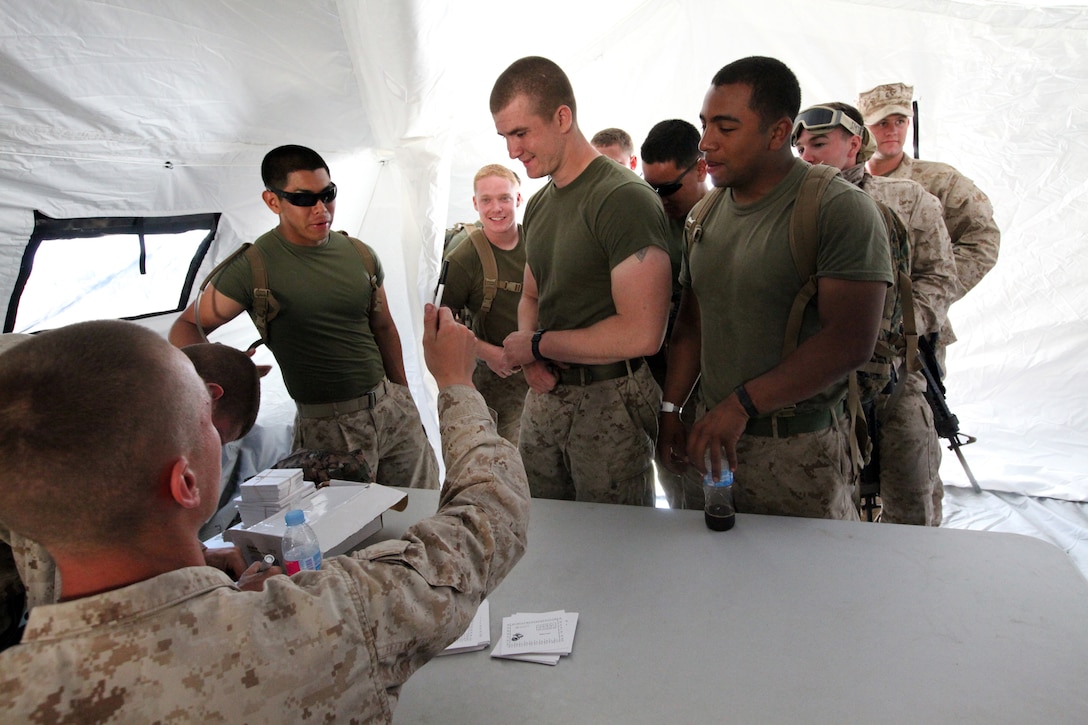 Sebastian Grisales, a poolee in the Marine Corps' delayed entry program waiting to go to recruit training, low crawls through the sand during a combat fitness test in Hollywood, Fla., June 25. Poolees participated in the CFT as part of a family day event organized by Marines with Recruiting Substation Hollywood, who said the added difficulty of running it on the beach will better prepare them for the physical demands of recruit training.