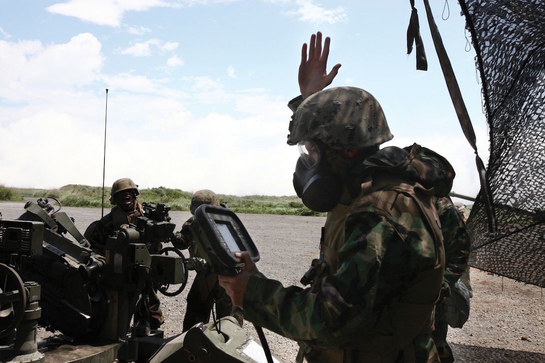 Staff Sgt. Joshua B. Barber, an artillery section chief with Kilo Battery, 3rd Battalion, 12th Marine Regiment, 3rd Marine Division, III Marine Expeditionary Force, wears Mission Oriented Protective Posture gear while directing his Marines as they prepare to fire a M777A2 howitzer during chemical, biological, radiological and nuclear training during Artillery Relocation Training Program 11-1 at the East Fuji Maneuver Area at Camp Fuji, Japan, June 25. The purpose of the CBRN training was to sustain Marines’ proficiency in conducting live-fire artillery operations while protecting themselves against the threat of CBRN contamination.