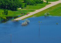 MINOT, N.D. -- Water fills a street in Minot, N.D., June 23, 2011. As many as 10,000 residents, about one-fourth of Minot's population, have evacuated the city as the fast-rising Souris River inundates thousands of himes and businesses. The Souris River is expected to crest at 1566 ft., nearly 9 ft. above the current level. (U.S. Air Force photo by Staff Sgt. Sharida Jackson) (RELEASED)