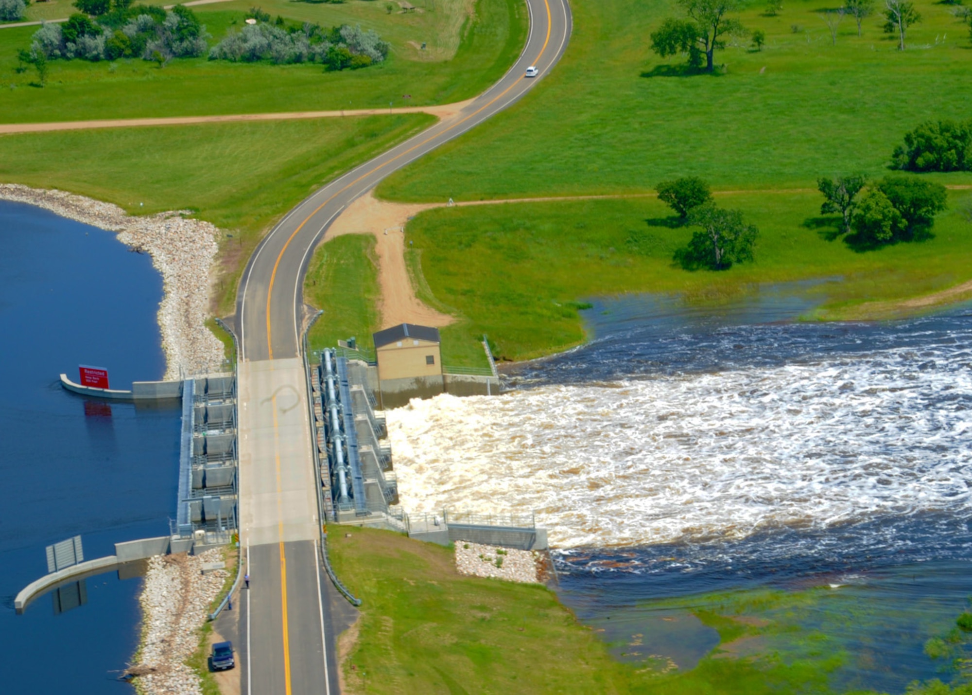 MINOT, N.D. -- Water flows through the Lake Darling Dam near Minot, N.D. June 23, 2011. The U.S. Army Corps of Engineers intend to raise the water release from Lake Darling to 28,000 cubic feet per second. (U.S. Air Force photo by Staff Sgt. Sharida Jackson) (RELEASED)