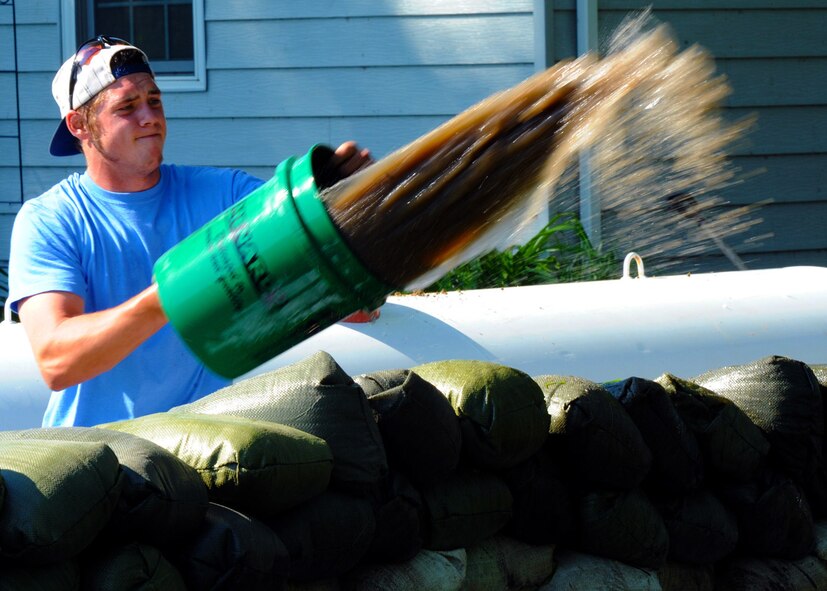 MINOT, N.D. -- Darren Back, Minot resident, removes water from a neighbor's yard in Minot, N.D., June 23, 2011. Minot Mayor Curt Zimbelman ordered the evacuation of nearly 12,000 of the city's residents as water began spilling over Minot's levees. The deluge from the Souris River is expected to exceed that of the city's historical 1969 flood, making this the region's worst flooding in four decades. (U.S. Air Force photo by Staff Sgt. Sharida Jackson) (RELEASED)