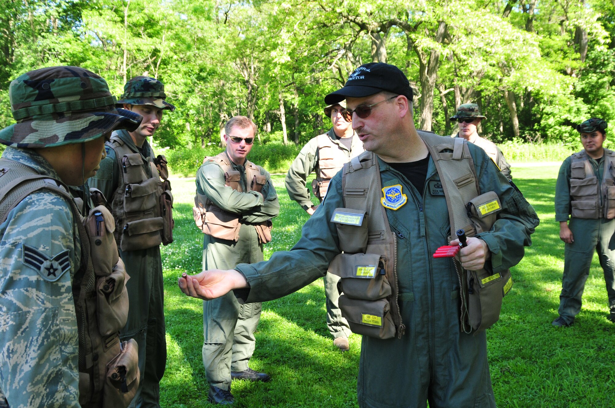 MILWAUKEE--An Airmen from the 128th Air Refueling Wing Life Support shop shows personal flares to gathered 128 ARW aircrew members during an annual training event on Saturday, June 25, 2011.  The annual training event included land navigation, open-water raft deployment, food procurement, and signal and vectoring methods.  (U.S. Air Force photo by Master Sgt. Kenneth Pagel / Released)