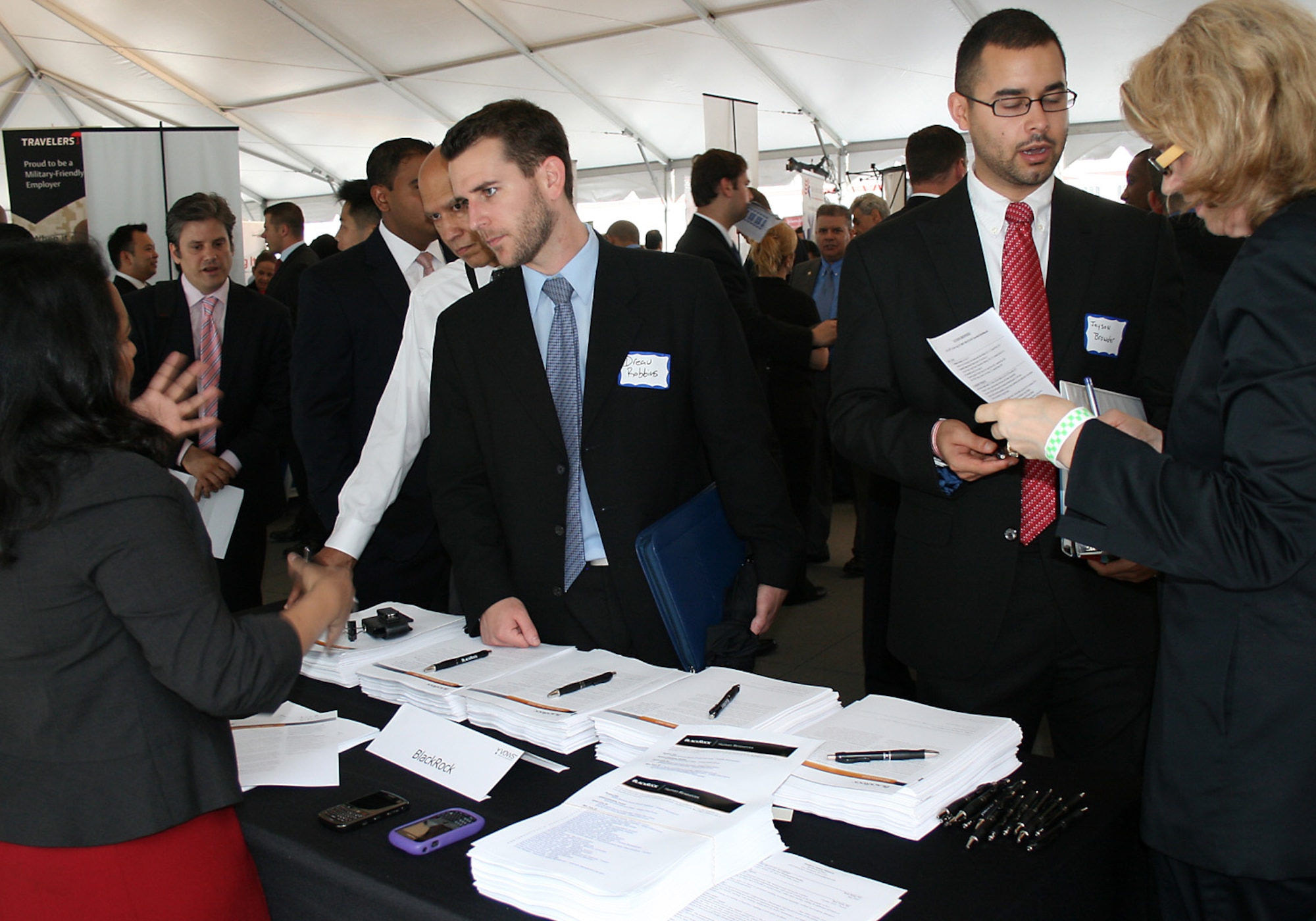 Jason Browder, second from right, awaits guidance from Louise Wood, right, of Black Rock, as she reviews the former active-duty Air Force senior airman's application submitted at the Hiring Our Heroes job fair June 23, 2011, in New York City. The veteran suggests service members begin their transition assistance as early as possible and their job search before they separate from the service. (U.S. Air Force photo/Tech. Sgt. Jennifer Lindsey)