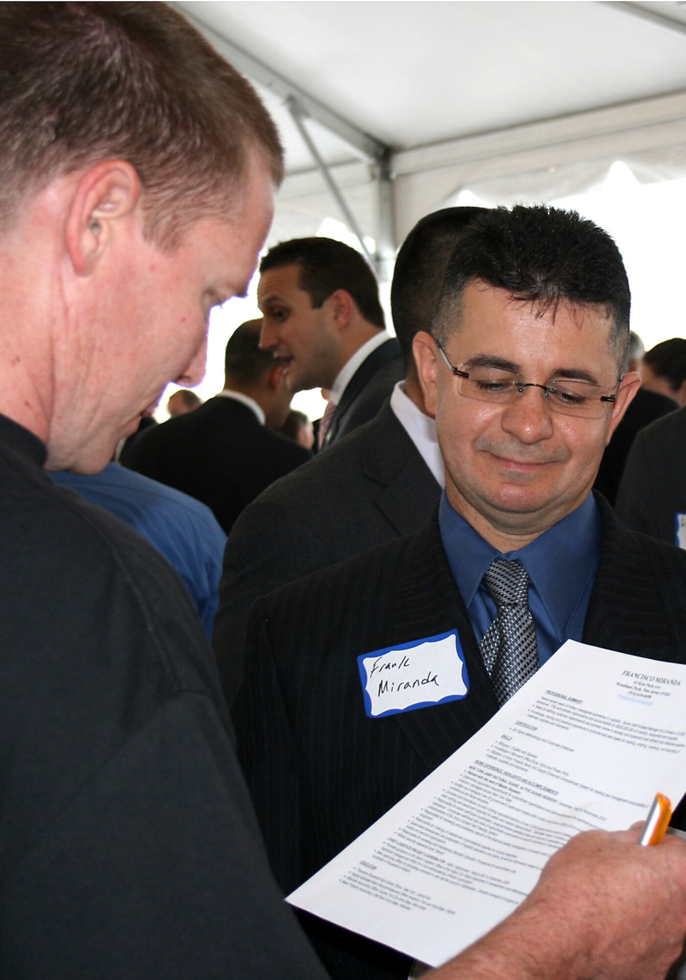 A potential employer reviews a job application submitted by Frank Miranda at the Hiring Our Heroes job fair June 23, 2011, in New York City. The Army master sergeant, who retired in September 2010 after 27 years of service, said he found the networking opportunities and websites referenced at the event most helpful. (U.S. Air Force photo/Tech. Sgt. Jennifer Lindsey)