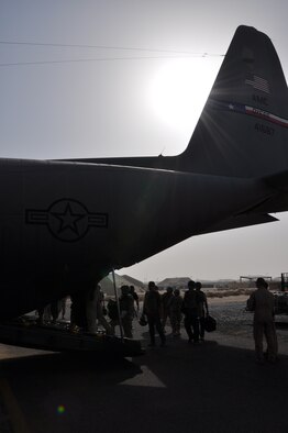 Approximately 40 passengers board a C-130 piloted by Col. Patrick Mordente, 386th Air Expeditionary Wing commander, June 23. This channel flight was dual-hatted as his fini-flight. (U.S. Air Force photo by Senior Airmen Rachelle Elsea)