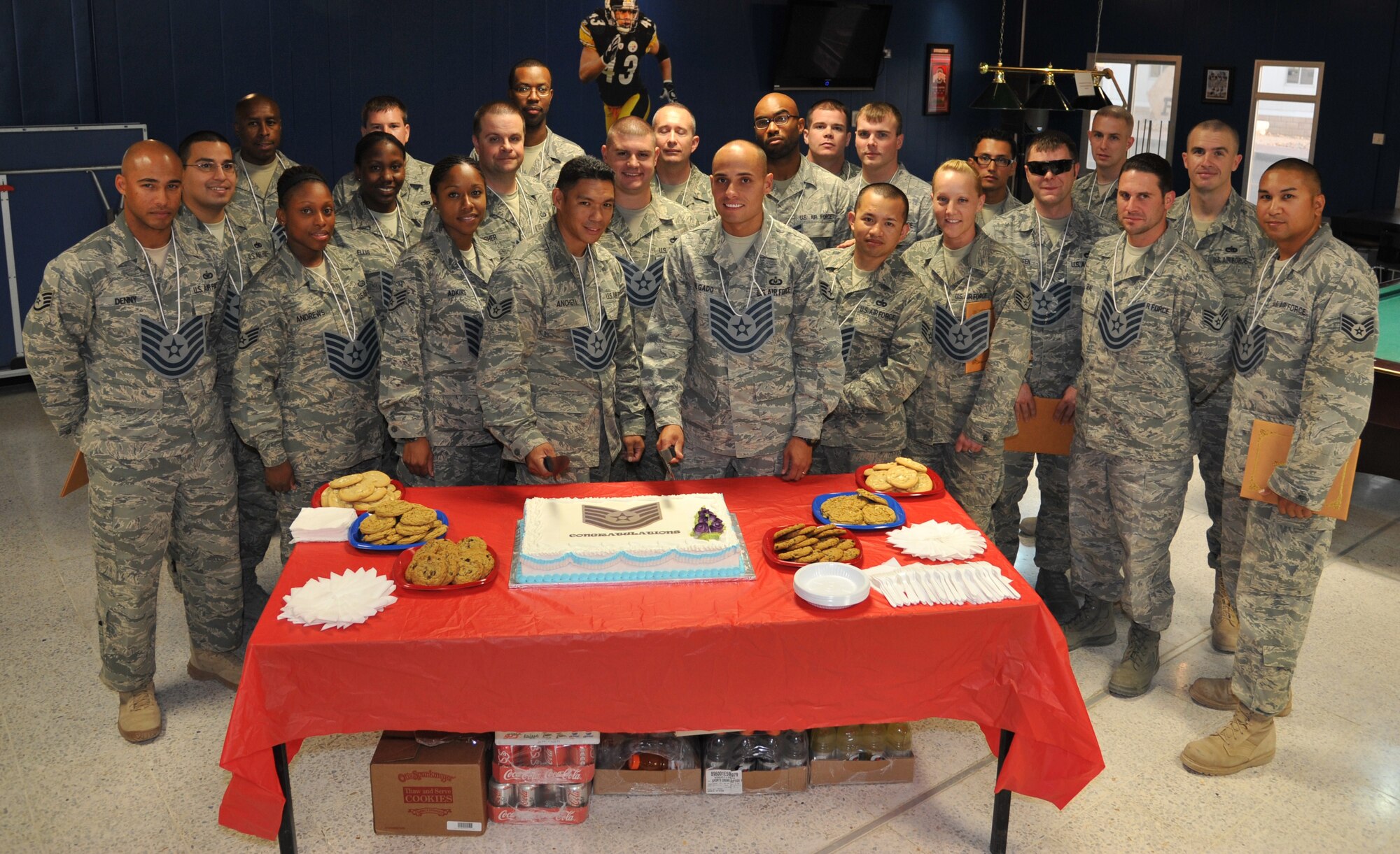 Technical Sergeant selects celebrate their upcoming promotion June 24 at an undisclosed location in Southwest Asia. (U.S. Air Force photo by Carlotta Holley)