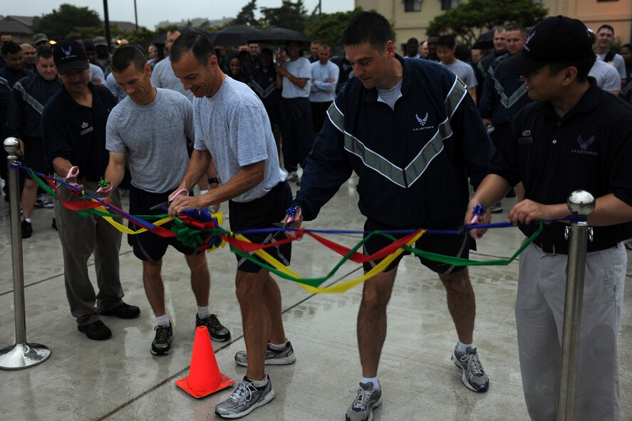 KUNSAN AIR BASE, Republic of Korea -- Despite heavy rain, the Wolf Pack came out in strong support for the grand opening of Kunsan's newest running track here June 24. (U.S. Air Force photo/Senior Airman Ciara Wymbs)