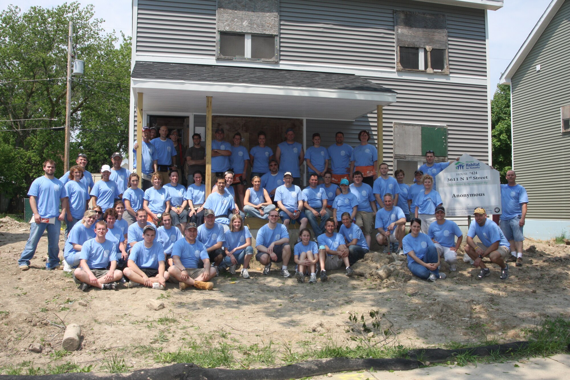 Sixty-Five Airmen and family members from the 128th Air Refueling Wing gather in front of an under-construction house in Milwaukee during a volunteer effort with Habitat for Humanity on Saturday, June 4, 2011.   The Airmen hanged drywall in four houses.  1st Lt. Gregory Damask, the 128th Air Refueling Wing Logistics Readiness Officer, organized the volunteer effort, and he looks forward to Airmen from the 128 ARW volunteering with Habitat for Humanity next year.  (U.S. Air Force photo by Master Sgt. Kenneth Pagel / Released)