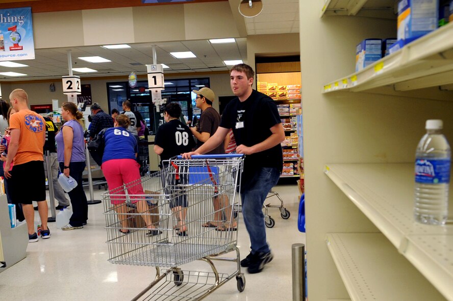 MINOT AIR FORCE BASE, N.D. -- A crowd of people rush to the commissary to buy water after hearing news of possible water contamination in the area here June 25. The commissary has distributed approximately 1500 gallons of water since the frenzy began and inventory levels have been elevated to meet the demand. (U.S. Air Force photo/Senior Airman Aaron-Forrest Wainwright)
