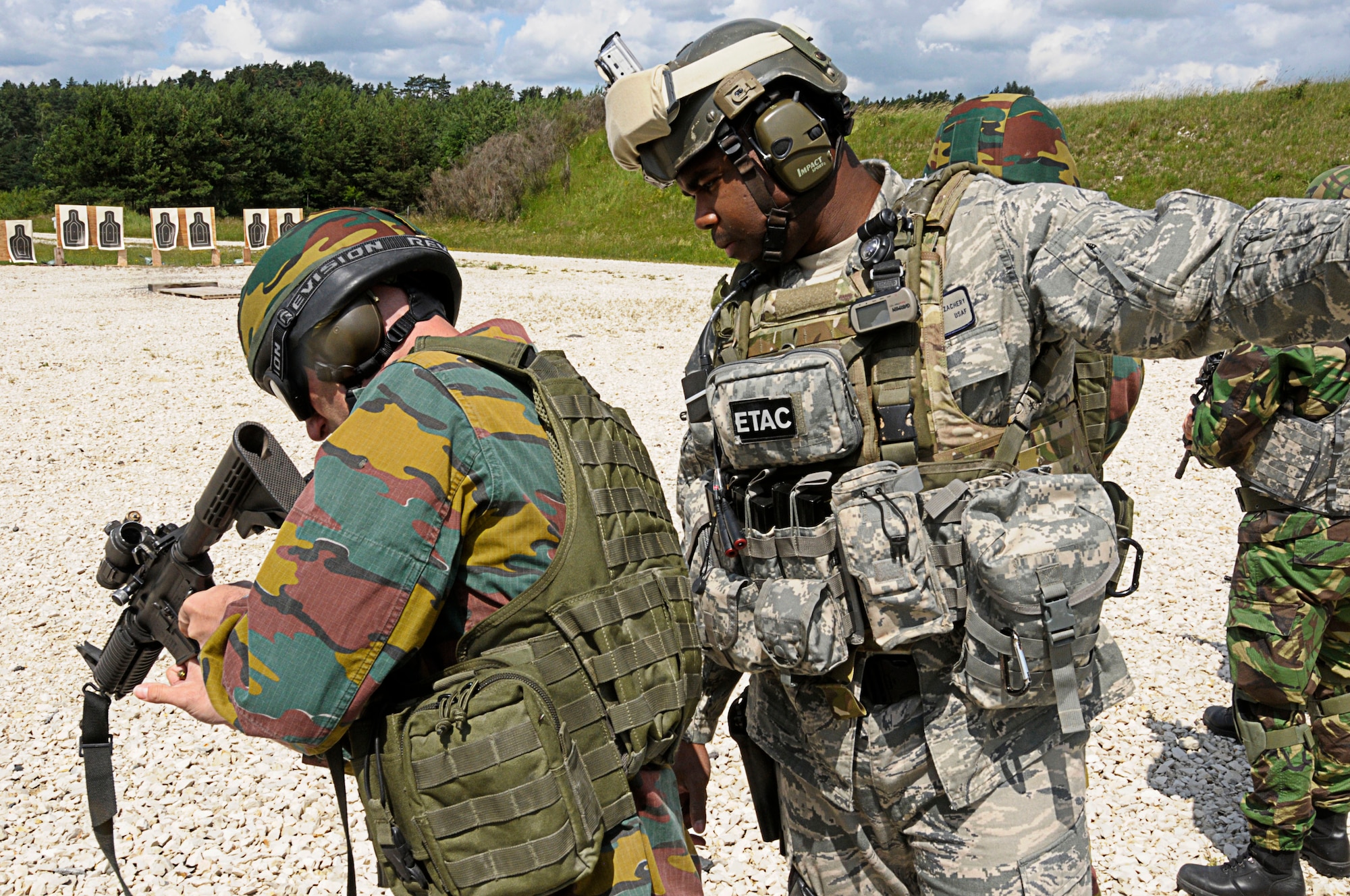 U.S. Air Force Master Sgt. Robert Zachary, 4th Air Support Operations Group, assists NATO armed forces personnel during weapons familiarization training at Allied Strike, held at Grafenwoehr Training Area, Germany, June 24, 2011. Allied Strike is Europe’s premier Close Air Support exercise, held annually to conduct robust, realistic CAS training that helps build partnership capacity among Allied NATO nations and refine the latest operational CAS tactics. (U.S. Air Force photo by Airman 1st Class Desiree W. Esposito)