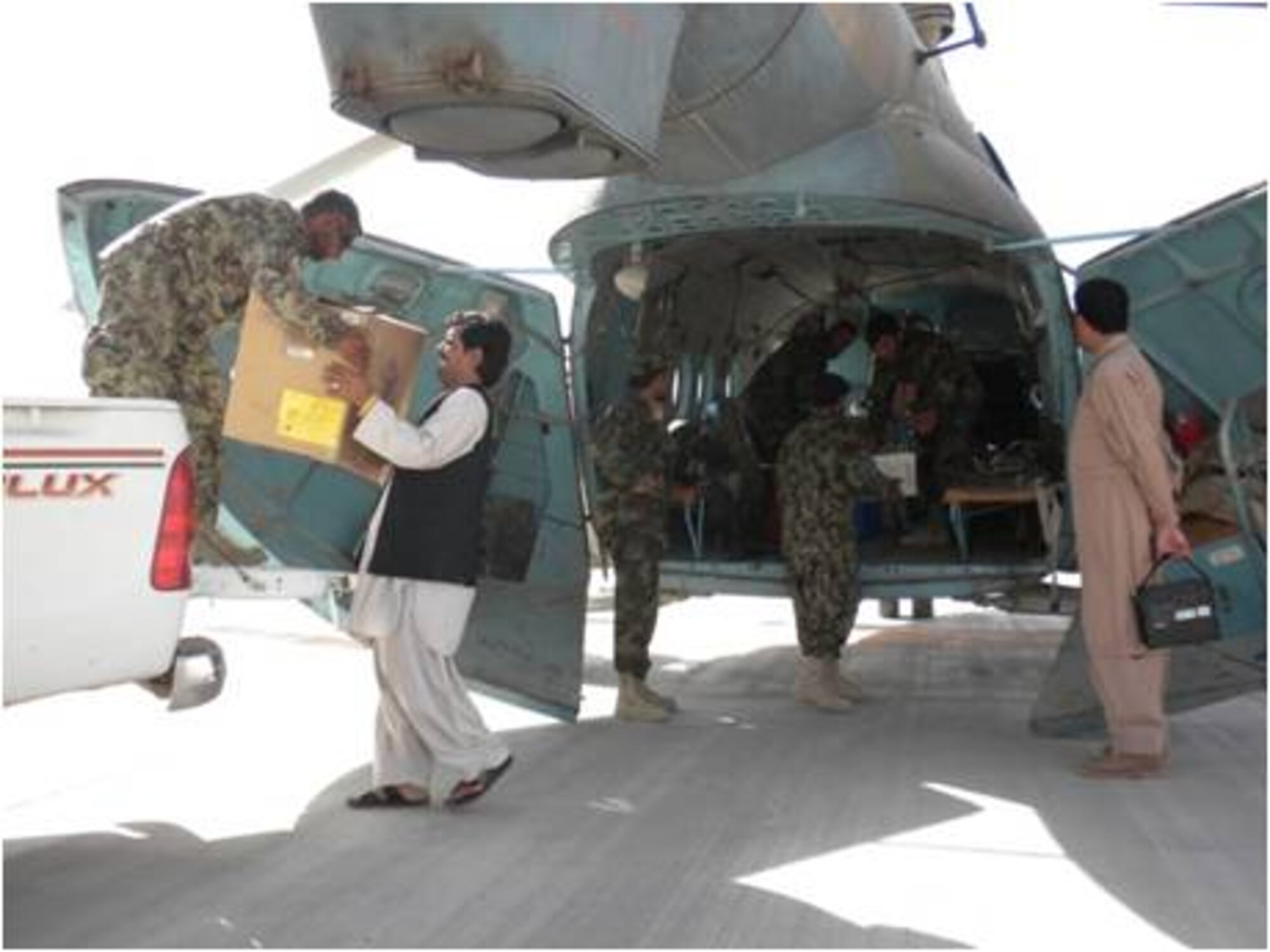 6/19/2011 – KANDAHAR, Afghanistan – Members of the Afghan Air Force help load medical supplies onto an Mi-17 recently.  Members of the AAF and 738th Air Expeditionary Advisory Group transported five physicians from Afghan Health Development Services, medical supplies and chlorine to the remote district of Ma’ruf in support of a cholera outbreak recently.  (U.S. Air Force courtesy photo)