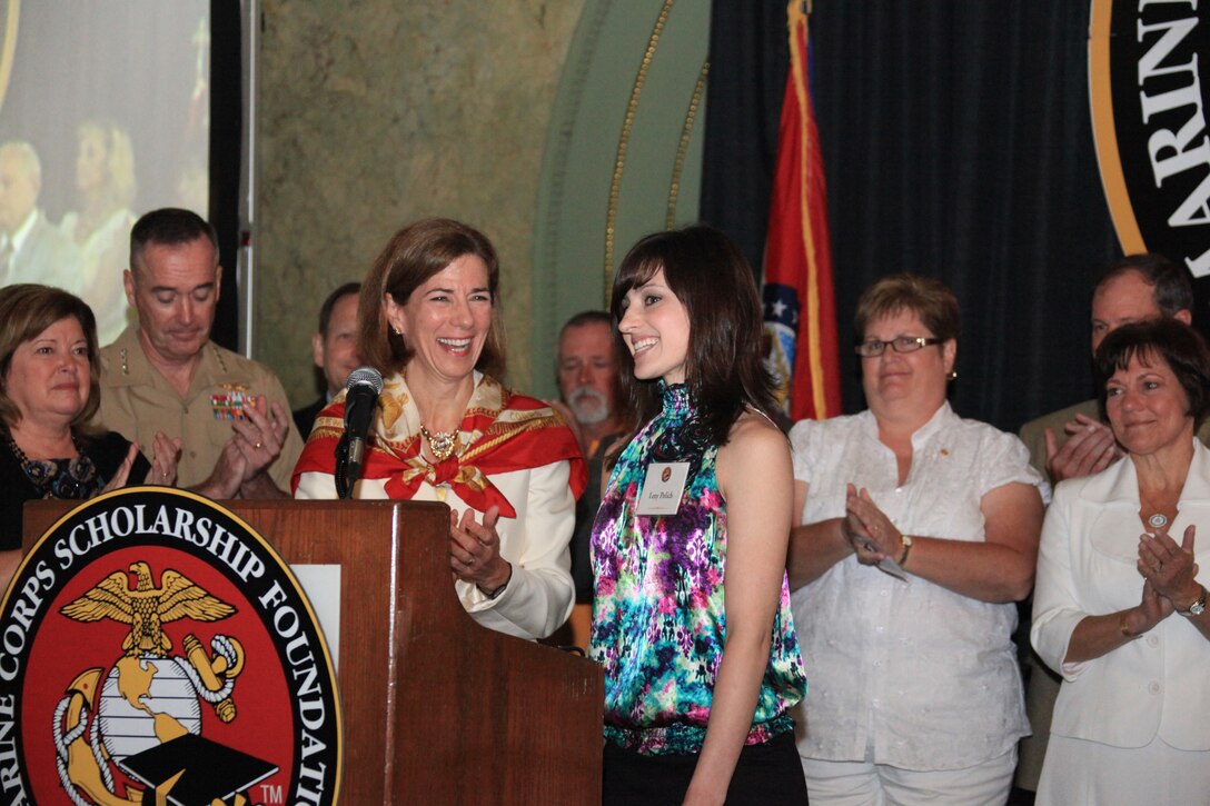Lexy Polich, daughter of reserve Staff Sgt. James Polich, receives the Lt. Robert Kelly Memorial Scholarship during the Gold Star Mother's Brunch at the St. Louis Union Station Marriott June 26, 2011. General and Mrs. John Kelly started the scholarship following the death of their son, 1st Lt. Robert Kelly, in Afghanistan last November.