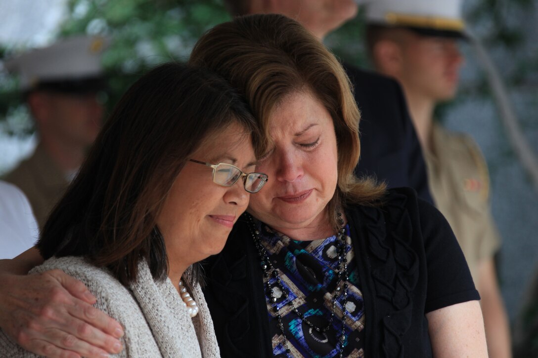 Karen Kelly, mother of 1st Lt. Robert Kelly, embraces a friend during the closing ceremony of Marine Week St Louis at the War Memorial June 26, 2011. 1st Lt. Kelly was killed in action in Afghanistan in 2010. Gold Star families were commended both at the Gold Star Mothers' brunch and later at the Marine Week St. Louis closing ceremony for their sacrifice and heart through their loss.