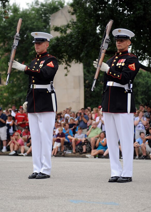 Lance Cpl. Jason Wynn and Lance Cpl. Michael Madulka, members of the Marine Corps Silent Drill Platoon inspection team, spin their rifles in unison during a performance in front of the St. Louis War Memorial during Marine Week 2011 June 26. The platoon traveled to St. Louis to perform two shows, one under the Gateway Arch and another during the closing ceremonies for Marine Week.