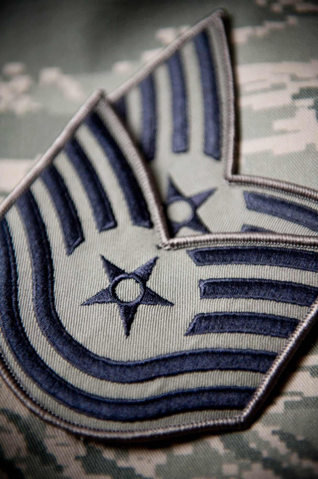 YOKOTA AIR BASE, Japan -- Technical sergeant stripes lie on an Airman Battle Uniform June 28, 2011. Air Force officials announced the results of the 2011 E-6 promotion cycle, naming approximately 8,500 eligible staff sergeants for promotion. (U.S. Air Force photo/Staff Sgt. Samuel Morse)