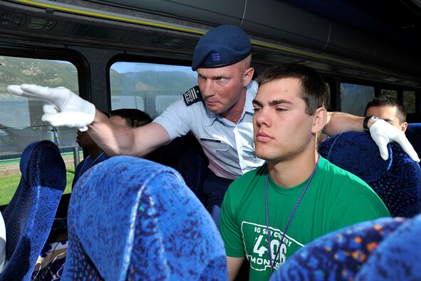 Air Force Academy Cadet 1st Class Zachary Crippen instructs a basic cadet to keep his eyes forward during the bus ride from Doolittle Hall to the Terrazzo June 25, 2011. Cadet Crippen is a cadre member assigned to Cadet Squadron 12. (U.S. Air Force photo/Megan Davis)