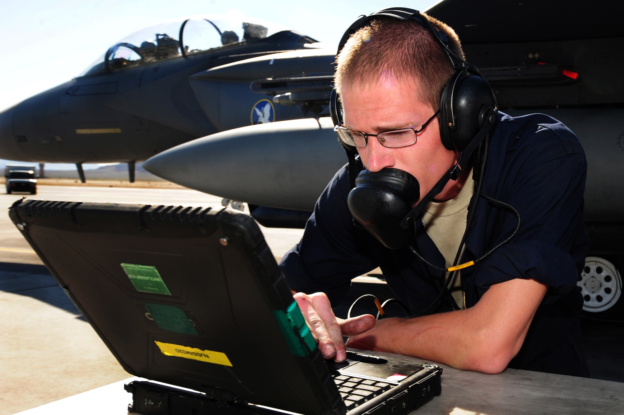 Airman 1st Class Justin Crumbley, 757th Aircraft Maintenance Squadron crew chief, reviews the checklist in the Integrated Maintenance Information System on an F-15 Eagle prior to take off at Nellis Air Force Base, Nev., June 14, 2011.   Airmen from the 757th Aircraft Maintenance Squadron accomplish intermediate-level maintenance on aircraft and support equipment components, maintaining avionics, laser guided weapons systems, pneudraulics, fuel systems, engines, measurement/diagnostic equipment, electro-environmental, and egress systems.  (U.S. Air Force photo by Staff Sgt. William P.Coleman)
  

