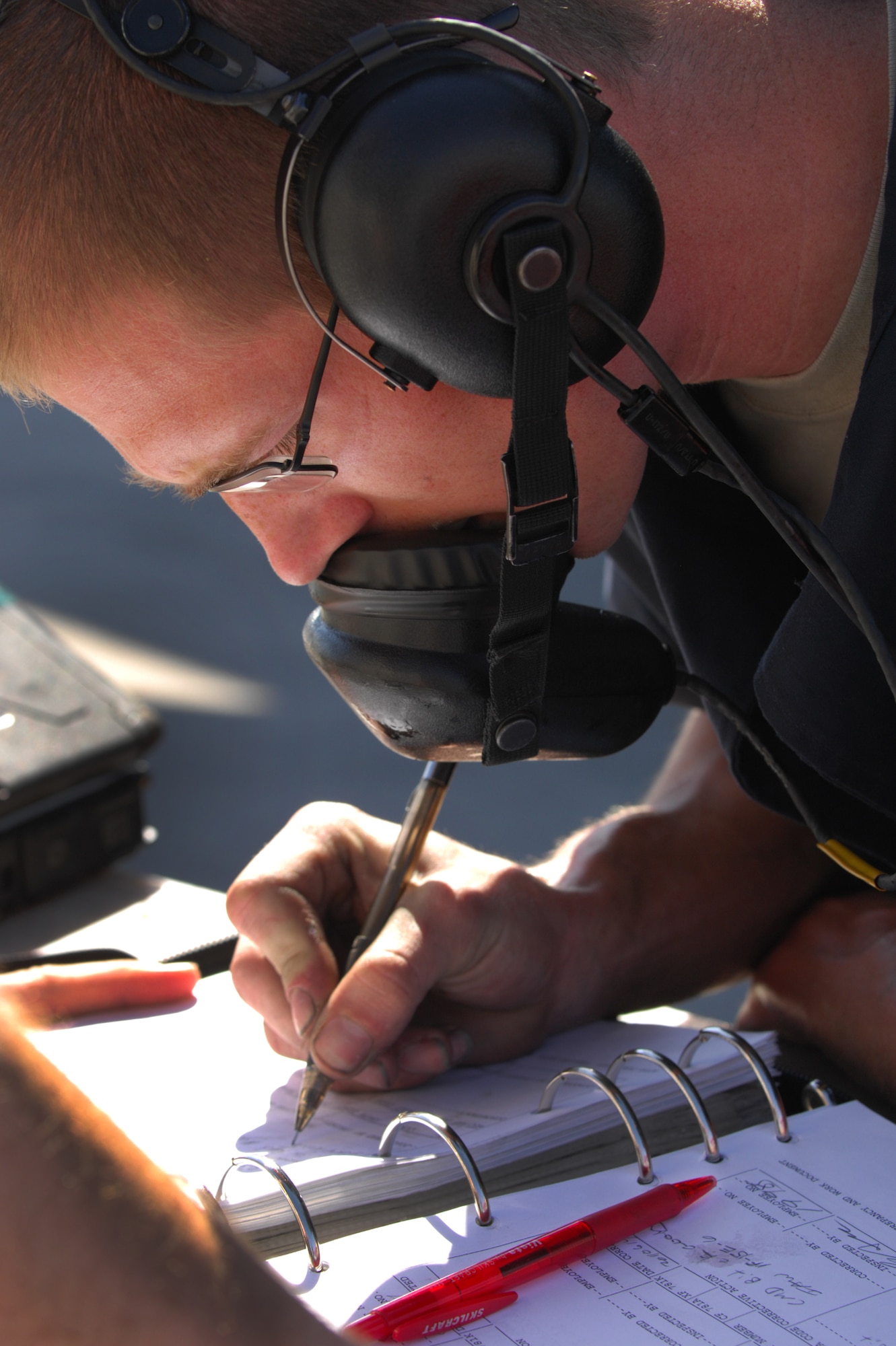 Airman 1st Class Justin Crumbley, 757th Aircraft Maintenance Squadron crew chief, signs maintenance forms after inspecting an F-15 Eagle prior to take off at Nellis Air Force Base, Nev., June 14, 2011.  Airmen from the 757th Aircraft Maintenance Squadron accomplish intermediate-level maintenance on aircraft and support equipment components, maintaining avionics, laser guided weapons systems, pneudraulics, fuel systems, engines, measurement/diagnostic equipment, electro-environmental, and egress systems.  (U.S. Air Force photo by Staff Sgt. William P.Coleman)
  

