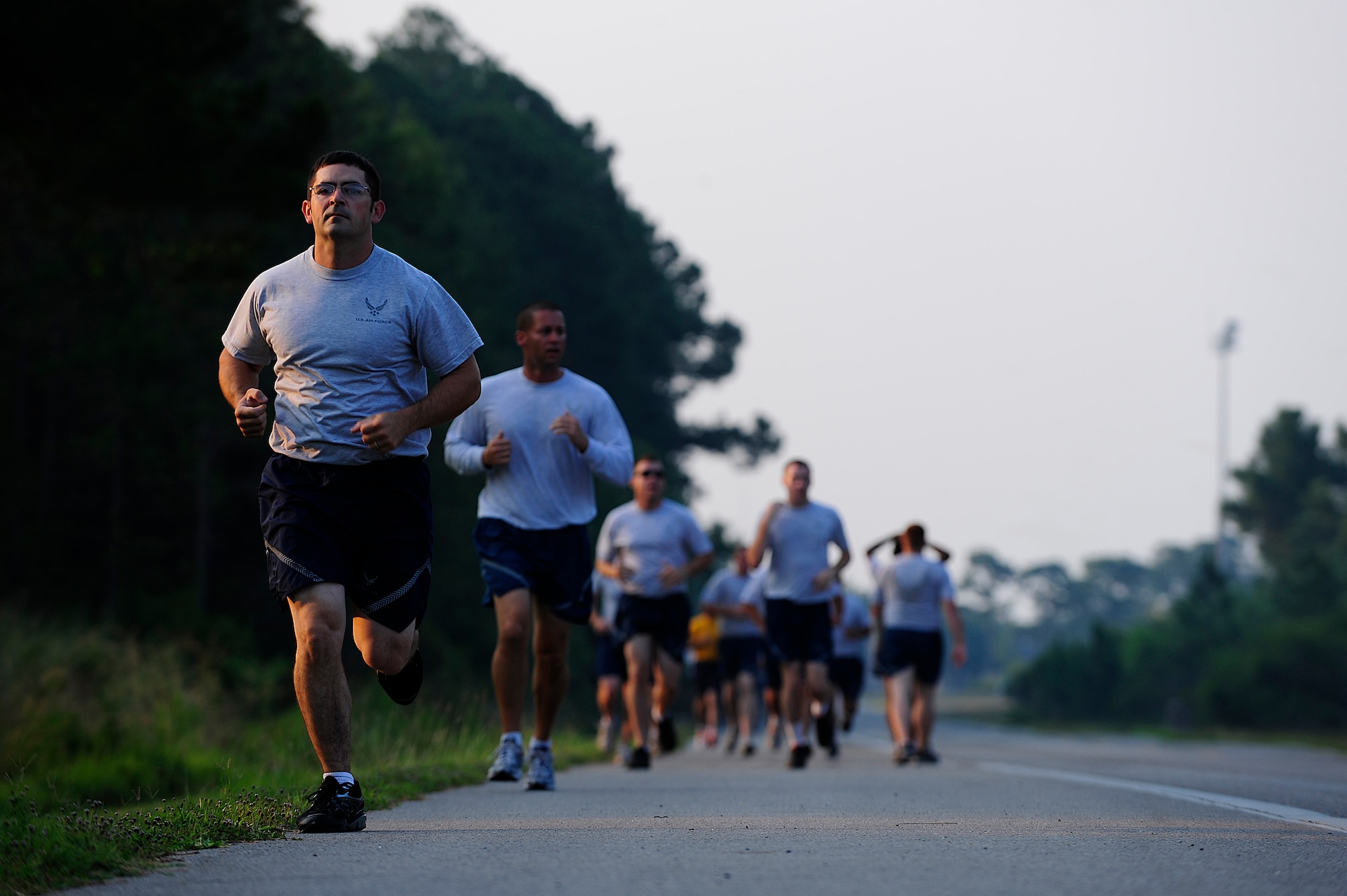 Members of the 823rd RED HORSE Squadron run during physical training, Hurlburt Field, Fla., June 13, 2011. The 823rd RHS set up a water station at the end of the running course to encourage proper hydration and reduce the likelihood of heat- related injuries. (U.S. Air Force photo by Staff Sgt. Julianne M. Showalter)

