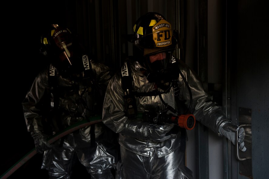 U.S. Air Force Staff Sgt. Nicholas Schnoes, 23rd Civil Engineer Squadron crew chief, supports another firefighter as they prepare to enter a room with a temperature of nearly 1,000 degrees Celsius during training at Moody Air Force Base, Ga., June 24, 2011. As the first team in tried to suppress the fire with a direct hit, a second team stayed behind to provide support if needed.
(U.S. Air Force photo by Airman 1st Class Nicholas Benroth/Released)