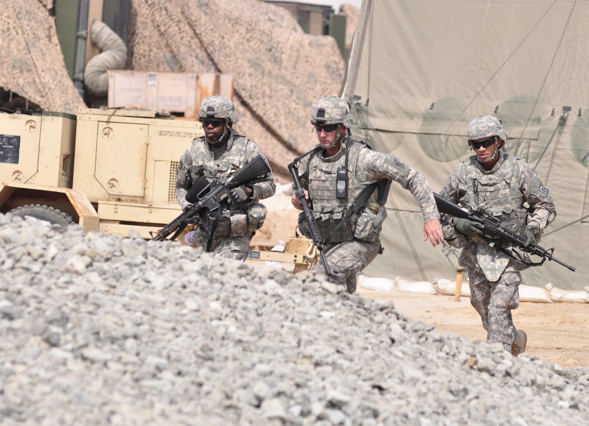 Soldiers assigned to the 3rd Battalion, 4th Air Defense Artillery Regiment cordon the initial perimeter in response to a simulated unexploded ordnance June 23, 2011, in Southwest Asia. The members of 3-4 ADAR trained alongside Airmen from the 380th Air Expeditionary Wing as part of a joint emergency response exercise to ensure the 380th AEW and mission partner readiness. (U.S. Air Force photo/Master Sgt. Chance Babin)
