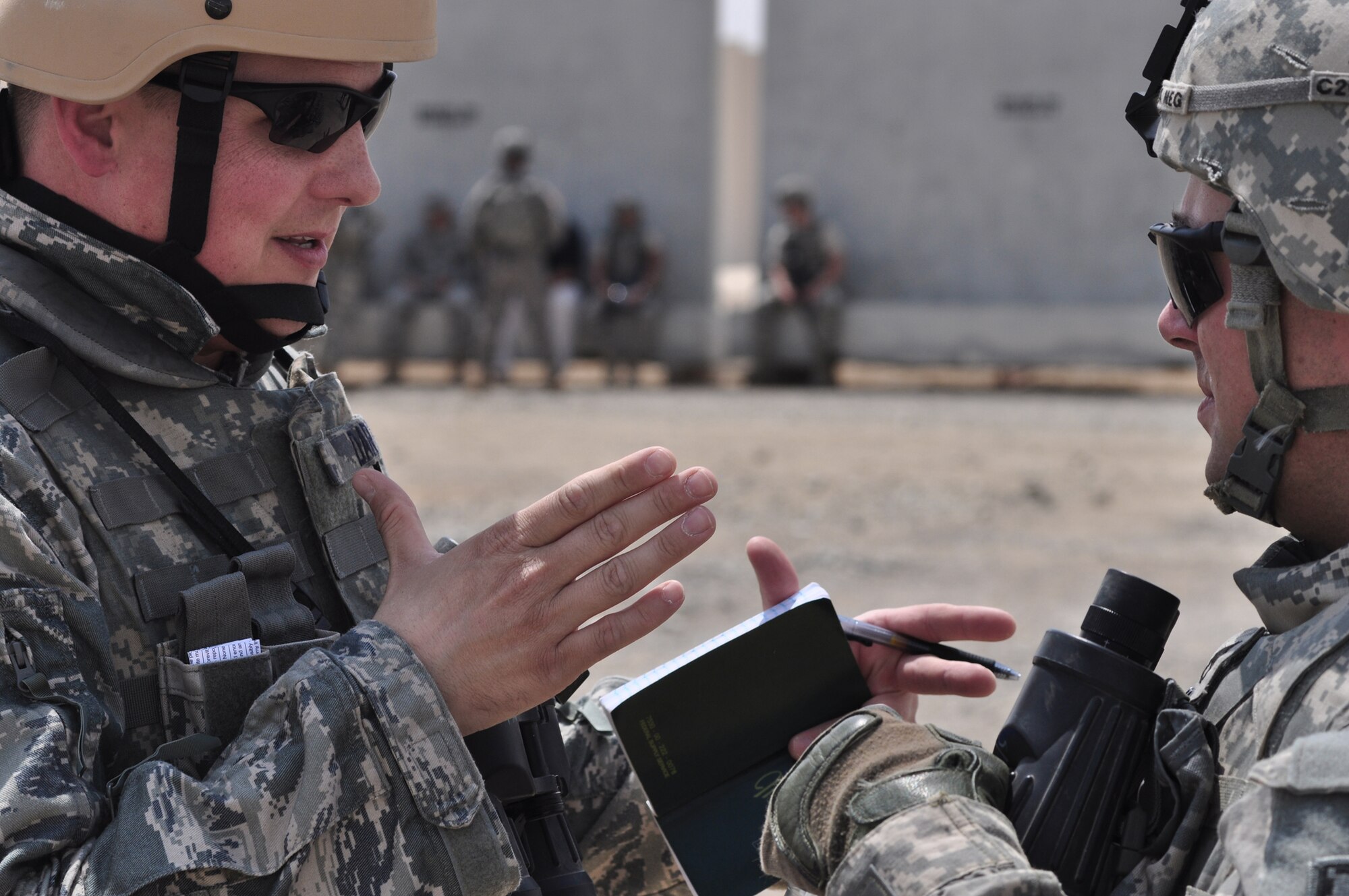 Staff Sgt. Michael Dart gets a report from  Army Staff Sgt. Brandon Combs on a simulated unexploded ordnance during a training exercise June 23, 2011, in Southwest Asia. The exercise incorporated Army and Air Force personnel ranging and was designed to prepare 380th AEW members and mission partners for real world scenarios. Sergeant Dart is a 380th Expeditionary Civil Engineer Squadron explosive ordinance team leader and Sergeant Combs is assigned to the 3rd Battalion, 4th Air Defense Artillery Regiment. (U.S. Air Force photo/Master Sgt. Chance Babin)