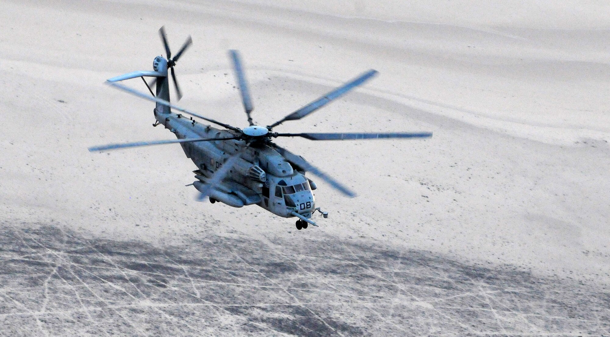 A Marine Corps MH-53 Pave Low helicopter flies over the Grand Bara Desert in Djibouti, June 16, 2011, in search of the “victims” of a simulated airplane crash.  The scenario was part of a joint personnel recovery training exercise involving all branches of the U.S. military stationed at Camp Lemonnier, Djibouti. (U.S. Air Force photo/Staff Sgt. Austin M. May)