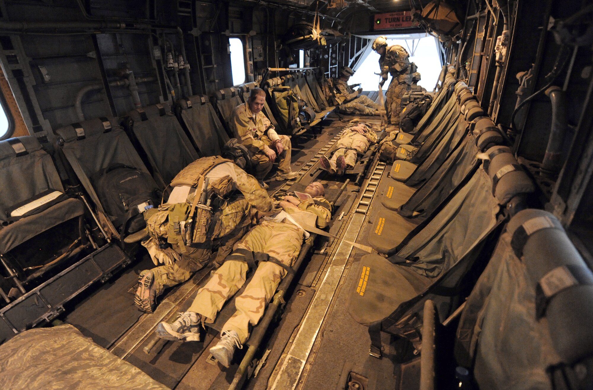 Air Force pararescuemen from the 82nd Expeditionary Rescue Squadron secure “victims” of a mock plane crash to the bed of a Marine Corps MH-53 Pave Low helicopter June 16, 2011, for transport. The scenario was part of a joint training exercise involving all branches of the U.S. military stationed at Camp Lemonnier, Djibouti. The 82nd ERQS is made up mostly of Airmen from the Air Force Reserve Command's 304th Rescue Squadron in Portland, Ore. (U.S. Air Force photo/Staff Sgt. Austin M. May)