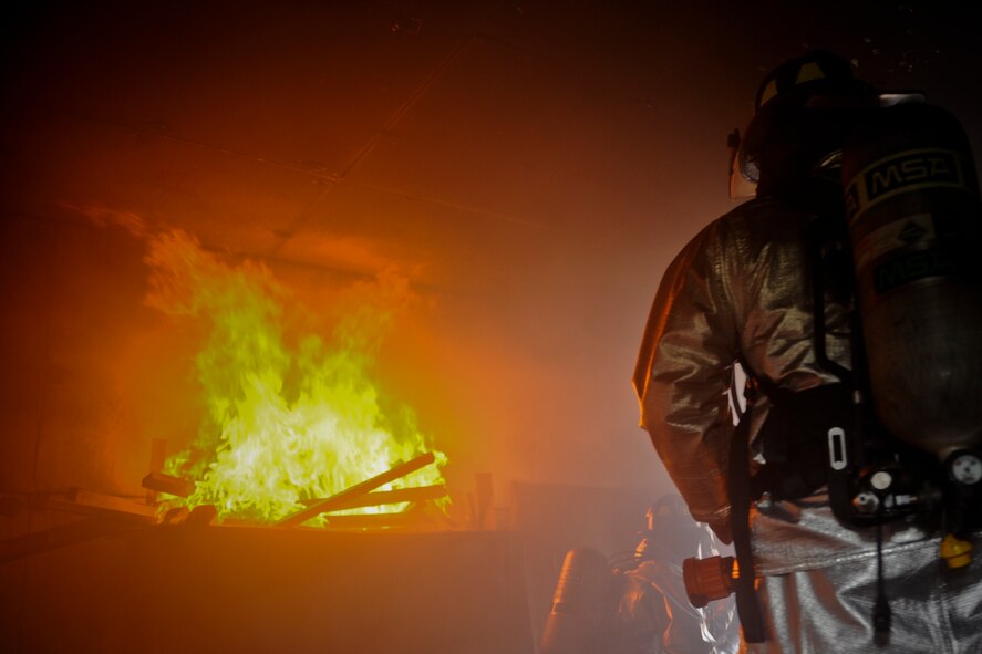 Firefighters from the 23rd Civil Engineer Squadron prepare to extinguish a fire during training at Moody Air Force Base, Ga., June 24, 2011. Depending on the size of a fire, teams can either work side by side to extinguish the fire or support each other in separate roles. (U.S. Air Force photo by Airman 1st Class Nicholas Benroth/Released)