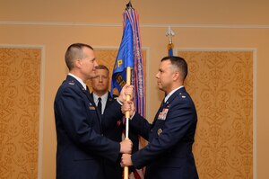 Lt. Col. Patrick M. Shortsleeve (right) accepts the guidon from Col. Paul Nelson, 480th Intelligence, Surveillance and Reconnaissance Wing commander, as he assumes command of the the 497 ISR Group during a change of command ceremony June 24 at the Bayview Commonwealth Center. Colonel Shortsleeve will command more than 800 personnel across four squadrons in a Total Force Integration environment, including two active-duty squadrons, one Air National Guard and one Reserve squadron. (U.S. Air Force photo by Airman 1st Class Rachael Watson/Released)
