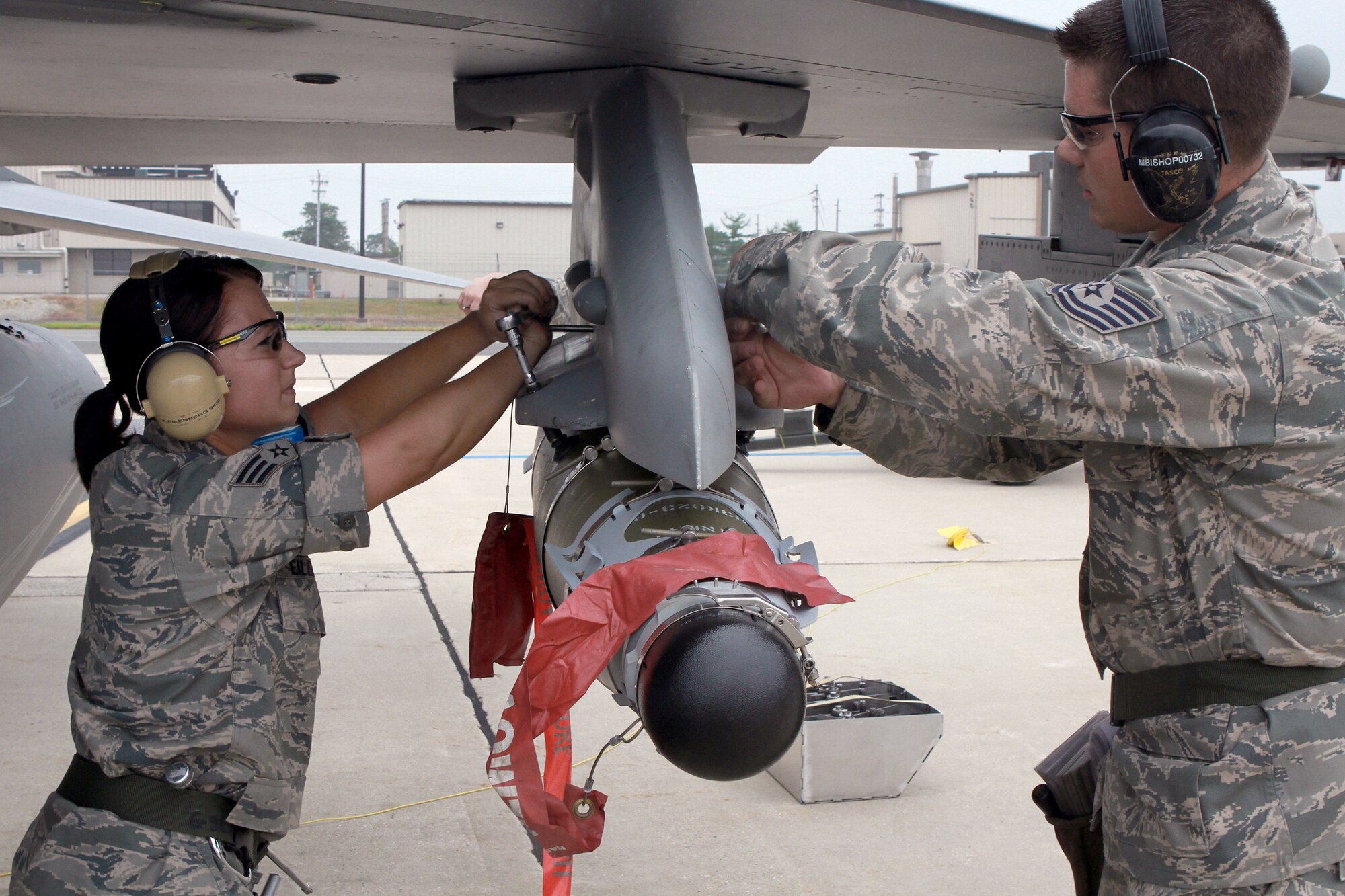Senior Airman Kelly Eilenberg (left) and Tech. Sgt. Michael Bishop lock a joint direct-attack munition June 12, 2011, during an annual load-crew competition at Egg Harbor Township, N.J. Sergeant Bishop and Airman Eilenberg are weapons loaders assigned to the New Jersey Air National Guard's 177th Fighter Wing. (U.S. Air Force photo/Master Sgt. Mark C. Olsen)