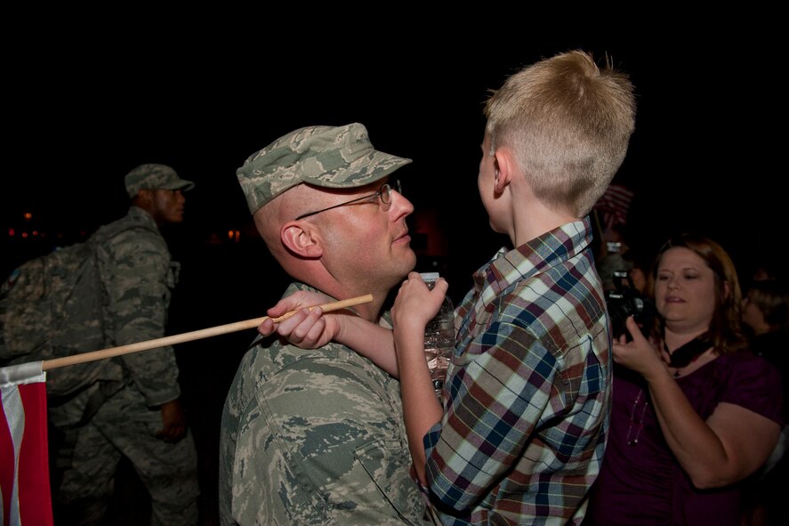 U.S. Air Force Tech. Sgt. James Vanover, 822nd Base Defense Squadron, holds his son James after returning home to Moody Air Force Base, Ga., June 26, 2011. Sergeant Vanover was part of a team who provided air base defense during a six-month deployment to Afghanistan. (U.S. Air Force photo by Staff Sgt. Jamal D. Sutter/Released)
