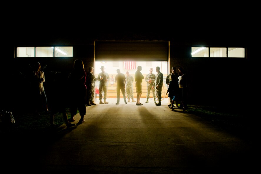 Friends and family wait to welcome returning 820th Base Defense Group Airmen the morning of June 26, 2011, at Moody Air Force Base, Ga. The welcome home team gathered with signs, refreshments and open arms for their loved ones who returned from a six-month deployment to Shindand Air Base, Afghanistan. (U.S. Air Force photo by Staff Sgt. Jamal D. Sutter/Released)
