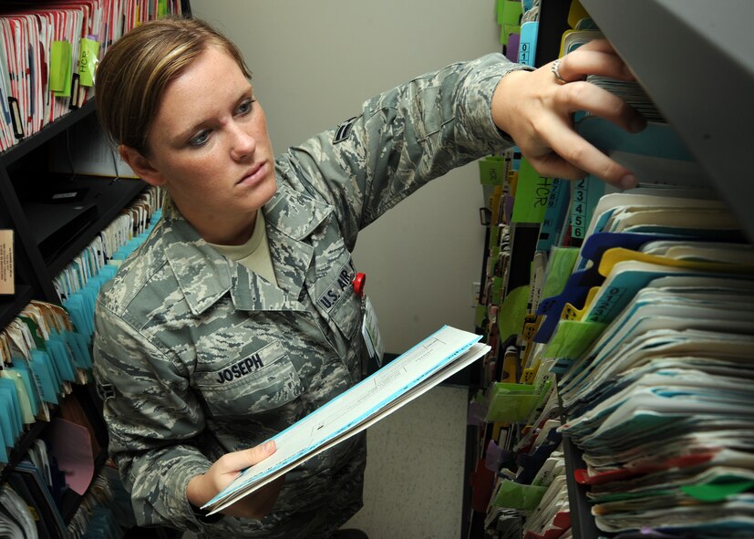 Airman 1st Class Hazel Joseph, 22nd Medical Group dental assistant, retrieves a patient’s medical records at the dental clinic June 17, 2011, McConnell Air Force Base, Kan.  The McConnell Dental Clinic received the 2010 Air Mobility Command Small Dental Clinic of the Year Award.  (U.S. Air Force photo/Staff Sgt. Dallas Edwards)