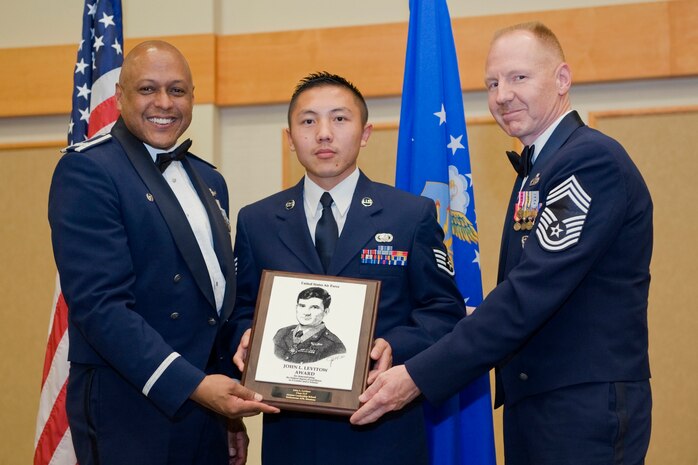 Staff Sgt. Vong Lee, 819th RED HORSE, center, receives the John L. Levitow award at the Airman Leadership School Class 11-F graduation banquet.  Shown presenting the award are Brig. Gen. (Sel) Anthony J. Cotton, 341st Missile Wing commander, and Chief Master Sgt. William C. Nygren, 16th Munitions Squadron superintendent.  The Levitow award is the highest honor given at all levels of enlisted professional military education.  The graduation banquet was held June 14, 2011 in the Grizzly Bend Club Community Activities Center at Malmstrom AFB, Mont.  (U.S. Air Force photo / Beau Wade)