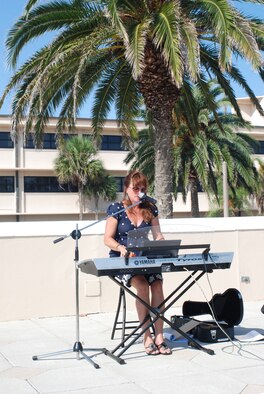 PATRICK AIR FORCE BASE, Fla.- Susan Jerome sings "Heroes Fight For Peace" at the Khobar Towers memorial here at Memorial Plaza. This memorial marks the 15 year anniversary of the terrorist bombing that took the lives of five Rescue Airmen from Patrick. The wing's primary wartime job is combat search and rescue, which involves locating and rescuing service members insolated in combat. (U.S Air Force photo/Airman First Class Natasha Dowridge) 

