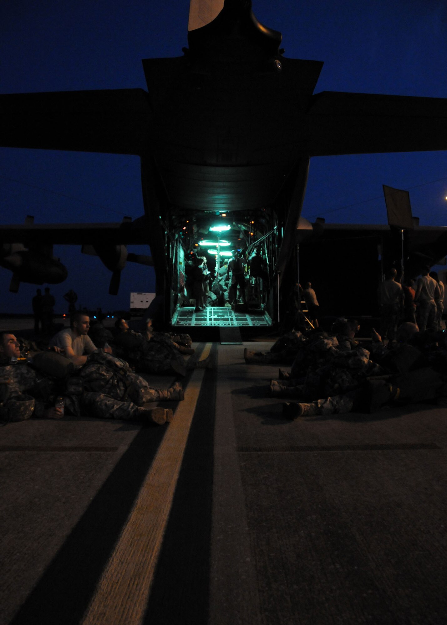 Army privates, students awaiting training at the U.S. Army Airborne School, wait to board the aircraft for a simulated jump on the flight line at Duke Field, Fla., June 15. The production company, WILL Interactive, started work on a choose-your-own-adventure film for Department of Defense jumpmaster training at Fort Benning, Ga., with help from members from the U.S. Army Airborne School. However, when the crew needed a C-130 in portions of the video, the 919th Special Operations Wing offered to support the project at Duke Field June 13-15. (U.S. Air Force photo/Tech. Sgt. Cheryl Foster)