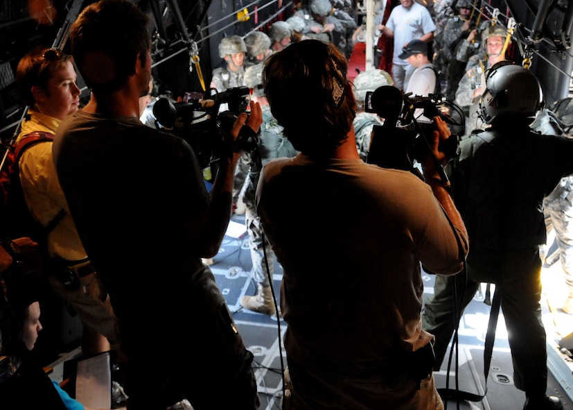 A video crew sets up to record a scene during a simulated jump on the flight line at Duke Field, Fla., June 14.  The production company, WILL Interactive, started work on a choose-your-own-adventure film for Department of Defense jumpmaster training at Fort Benning, Ga., with help from members from the U.S. Army Airborne School. However, when the crew needed a C-130 in portions of the video, the 919th Special Operations Wing offered to support the project at Duke Field June 13-15. (U.S. Air Force photo/Tech. Sgt. Cheryl Foster)  