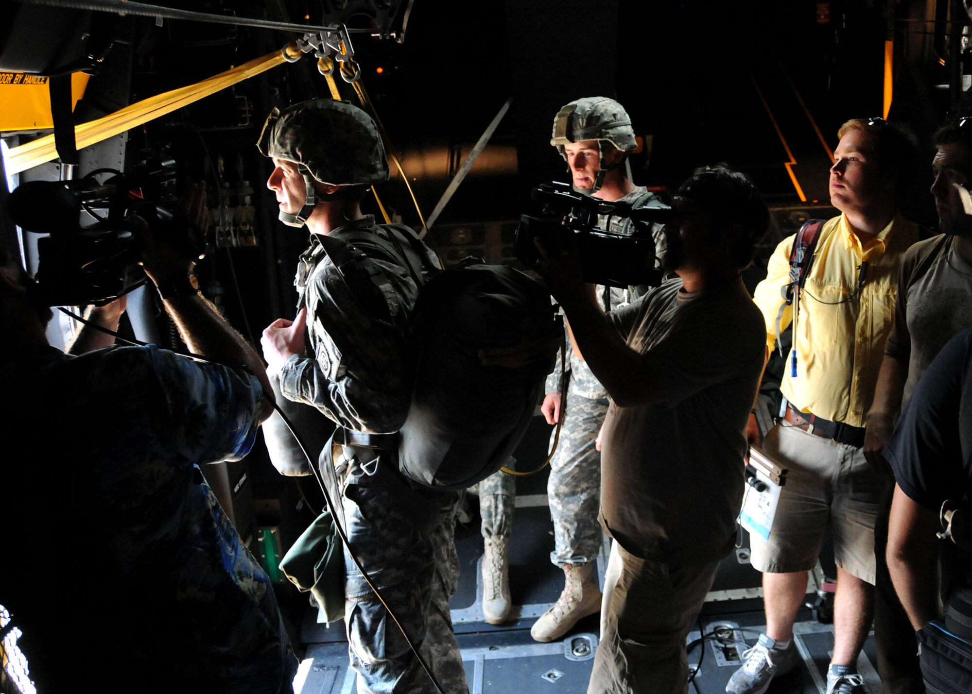 A video crew sets up to record a scene during a simulated jump on the flight line at Duke Field, Fla., June 14.  The production company, WILL Interactive, started work on a choose-your-own-adventure film for Department of Defense jumpmaster training at Fort Benning, Ga., with help from members from the U.S. Army Airborne School. However, when the crew needed a C-130 in portions of the video, the 919th Special Operations Wing offered to support the project at Duke Field June 13-15. (U.S. Air Force photo/Tech. Sgt. Cheryl Foster)