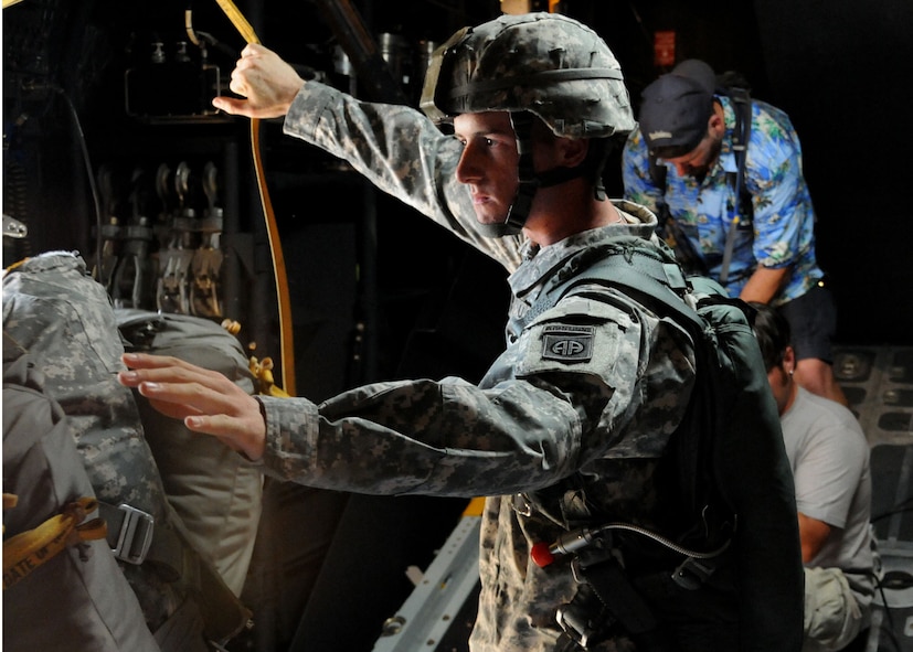 Army Private William Lourash, a student awaiting training at the U.S. Army Airborne School, portrays a jumpmaster during a simulated jump on the flight line at Duke Field, Fla., June 14.  The production company, WILL Interactive, started work on a choose-your-own-adventure film for Department of Defense jumpmaster training at Fort Benning, Ga., with help from members from the U.S. Army Airborne School. However, when the crew needed a C-130 in portions of the video, the 919th Special Operations Wing offered to support the project at Duke Field June 13-15. (U.S. Air Force photo/Tech. Sgt. Cheryl Foster) 