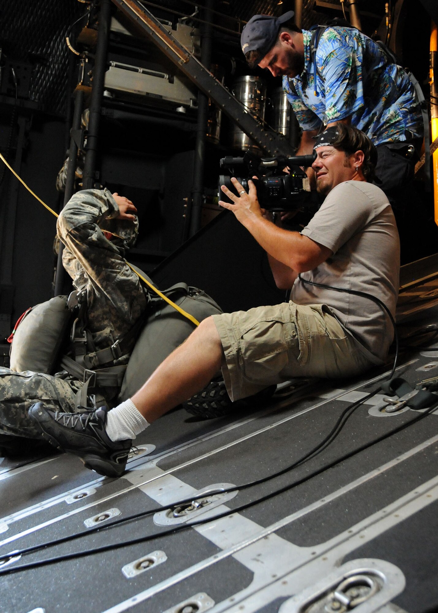 Michael Jechort and Luke Rocheleau, videographers, record a simulated jump scene on the flight line at Duke Field, Fla., June 14. The production company, WILL Interactive, started work on a choose-your-own-adventure film for Department of Defense jumpmaster training at Fort Benning, Ga., with help from members from the U.S. Army Airborne School. However, when the crew needed a C-130 in portions of the video, the 919th Special Operations Wing offered to support the project at Duke Field June 13-15. (U.S. Air Force photo/Tech. Sgt. Cheryl Foster)