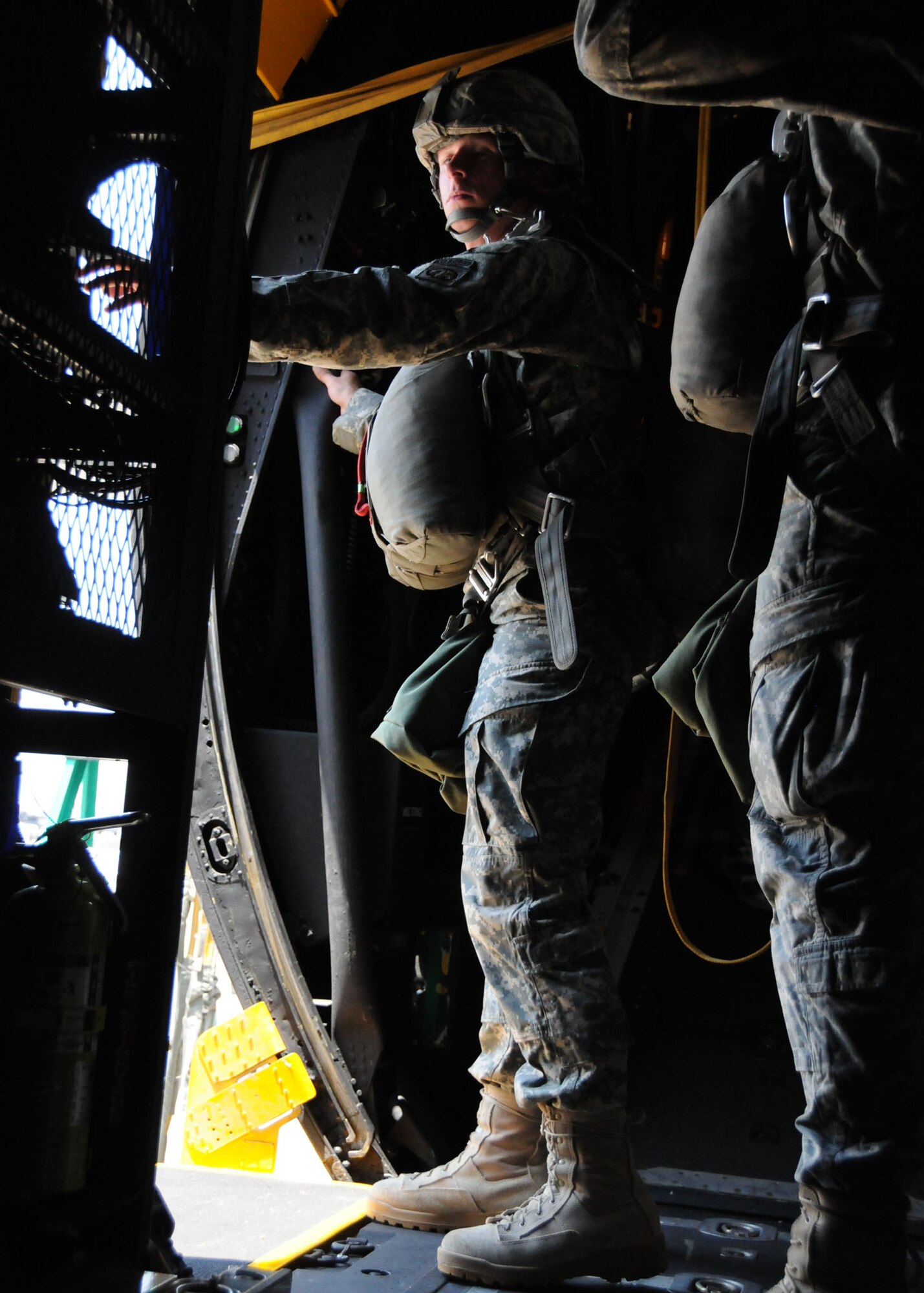 Will Illg, an actor, braces himself in the open door of an MC-130E aircraft for a simulated jump on the flight line at Duke Field, Fla., June 14. The production company, WILL Interactive, started work on a choose-your-own-adventure film for Department of Defense jumpmaster training at Fort Benning, Ga., with help from members from the U.S. Army Airborne School. However, when the crew needed a C-130 in portions of the video, the 919th Special Operations Wing offered to support the project at Duke Field  June 13-15. (U.S. Air Force photo/Tech. Sgt. Cheryl Foster)