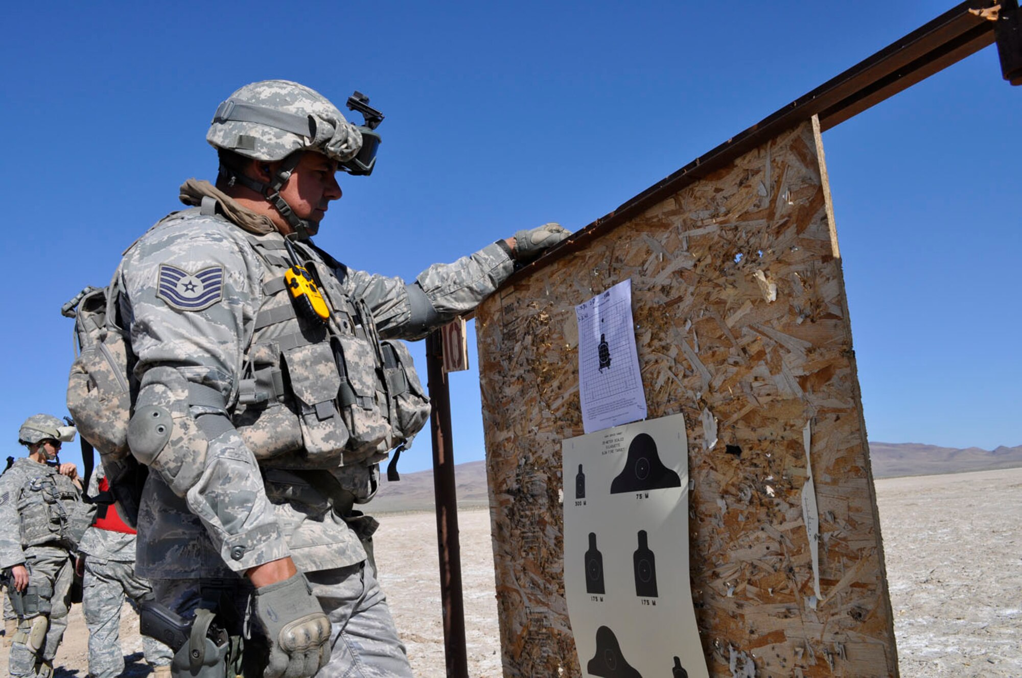 Tech. Sgt. Jason Aceves reviewing his zeroing target before qualifying on the M-4.