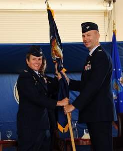 Col.Justin Davey accepts the 628th Mission Support Group guidon from Col. Martha Meeker during the 628th MSG Change of Command June 27 at Joint Base Charleston. Colonel Davey is the new 628 MSG commander and Colonel Meeker is the 628th Air Base Wing commander. (U.S. Air Force photo/ Tech. Sgt. Chrissy Best)

