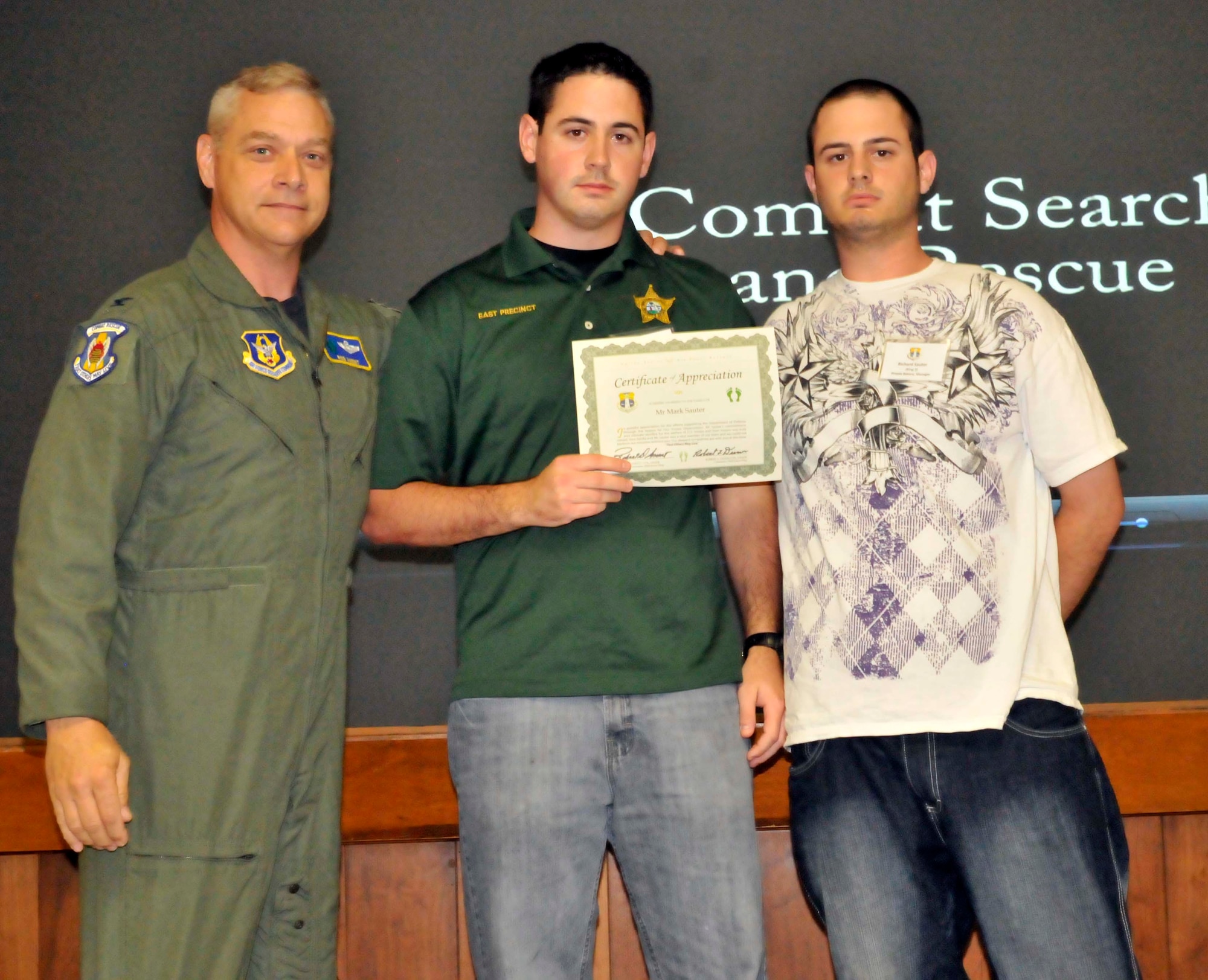 PATRICK AIR FORCE BASE, Fla.- Colonel Robert Ament, 920th Rescue Wing Vice Commander, presents a certificate of appreciation to local members of the Cocoa Beach community. As Vice Commander, Col. Ament assists in overseeing support to the neighboring cities. (U.S. Air Force Photo/Airmen First Class Natasha Dowridge)