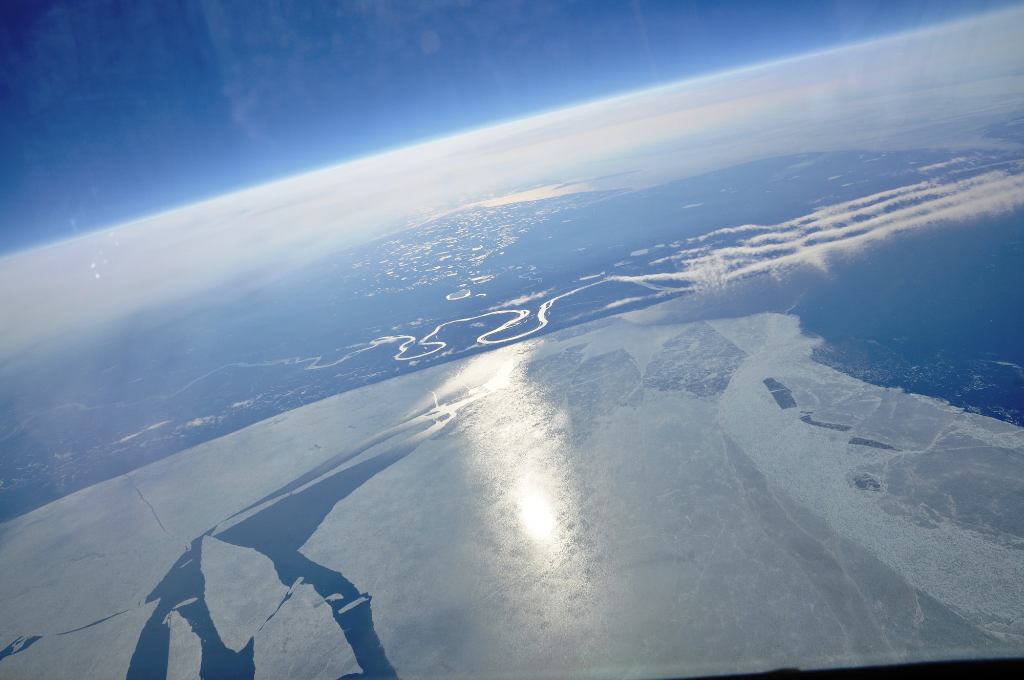 Views from a KC-135 Stratotanker cockpit reveal icy plateaus over the Arctic on June 22, 2011.  A tanker crew from Fairchild Air Force Base, Wash., flew over the North Pole for the first time June 21 to 22, 2011, as part of an “iron swap” mission along a new, more efficient route from Moses Lake, Wash., to the Transit Center at Manas, Kyrgyzstan.  (U.S. Air Force Photo/Capt. Kathleen Ferrero)