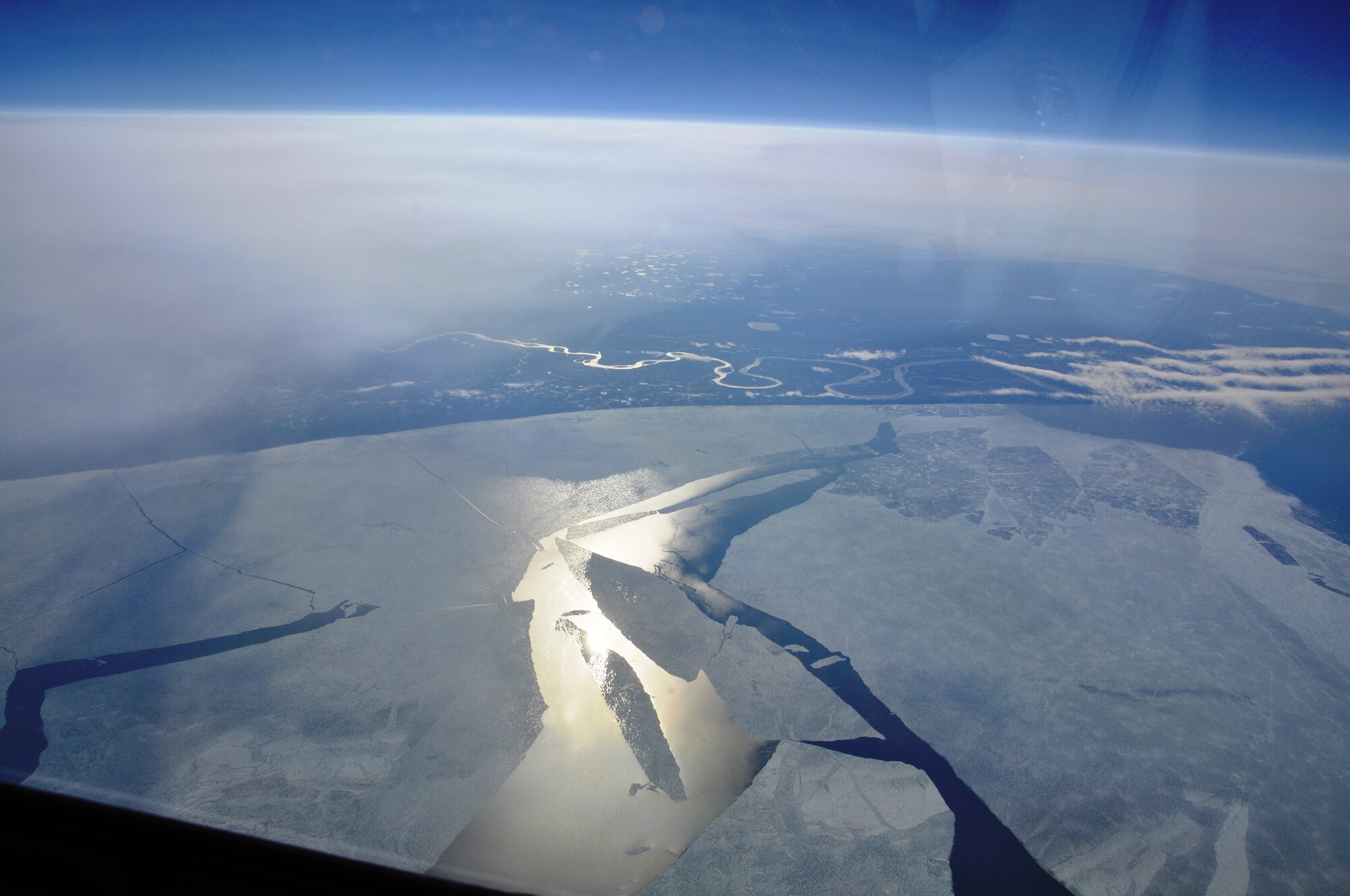 Views from a KC-135 Stratotanker cockpit reveal icy plateaus over the Arctic on June 22, 2011.  A tanker crew from Fairchild Air Force Base, Wash., flew over the North Pole for the first time June 21 to 22, 2011, as part of an “iron swap” mission along a new, more efficient route from Moses Lake, Wash., to the Transit Center at Manas, Kyrgyzstan.  (U.S. Air Force Photo/Capt. Kathleen Ferrero)
