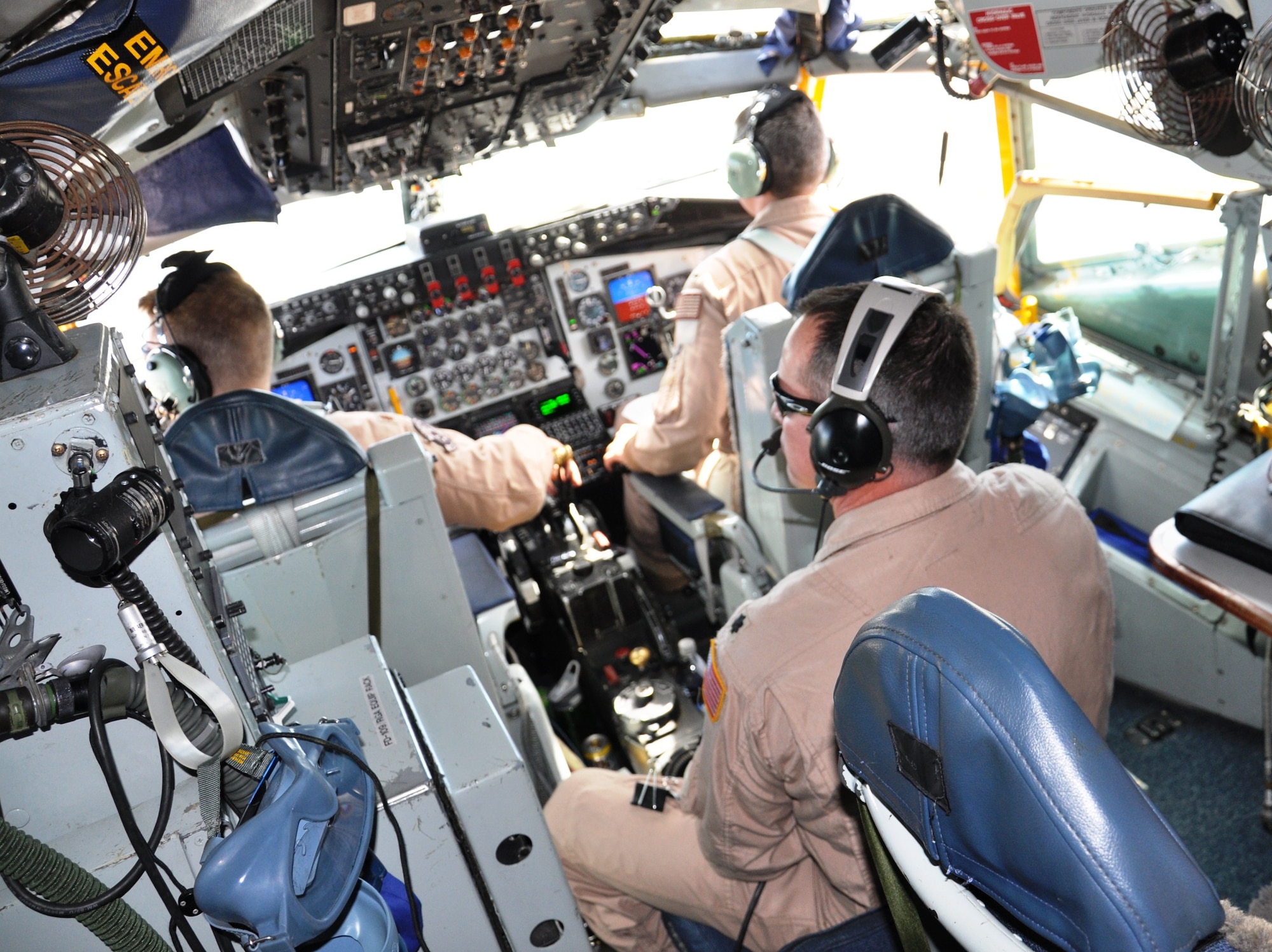 KC-135 pilots accomplish pre-flight checklist tasks at Moses Lake, Wash., prior to takeoff on a historic Arctic over-flight mission June 21, 2011, from Washington state to the Transit Center at Manas, Kyrgyzstan.  Pictured here are: (clockwise from top left) Maj. Jeff Schrum, 1st Lt. Remington Barnes and Lt. Col. Thorne Tibbett. The Fairchild Air Force Base, Wash., tanker crew flew over the North Pole for the first time June 21 to 22, 2011,  as part of an “iron swap” mission along a new, more efficient route from Moses Lake, Wash., to Kyrgyzstan.   (U.S. Air Force Photo/Capt. Kathleen Ferrero)