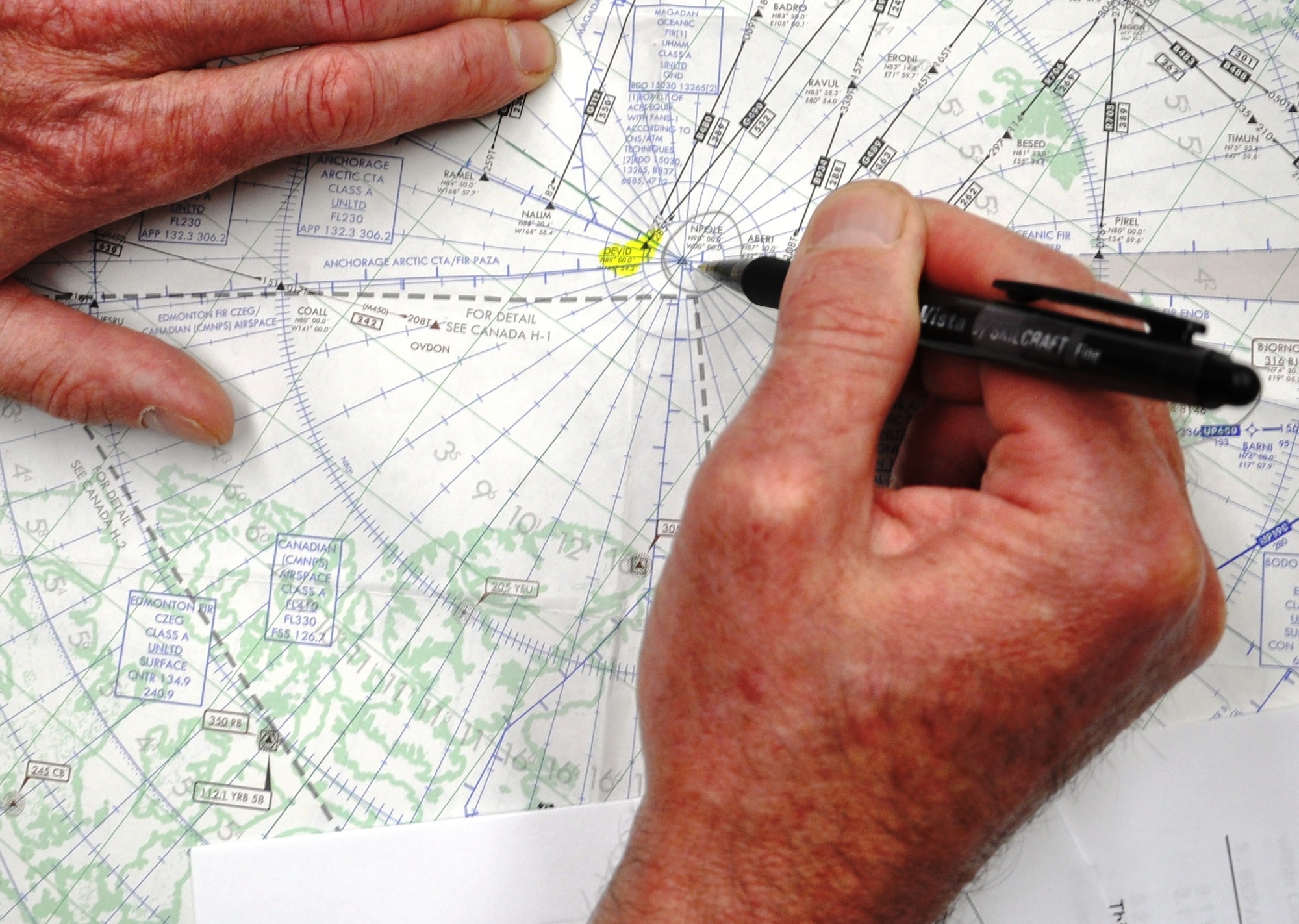 Lt. Col. Thorne Tibbitts marks the point on a map June 21, 2011, at Fairchild Air Force Base, Wash., showing the proximity to the North Pole in the Arctic Circle that his KC-135 Stratotanker crew was preparing to fly (KC-135 route is highlighted in yellow). Colonel Tibbitts is an Air National Guardsman and commander of the 141st Aircraft Maintenance Generation Squadron at Fairchild Air Force Base.  The KC-135 flew over the North Pole for the first time June 21 to 22, 2011, as part of an “iron swap” mission along a new, more efficient route from Moses Lake, Wash., to the Transit Center at Manas, Kyrgyzstan.  (U.S. Air Force Photo/Capt. Kathleen Ferrero)