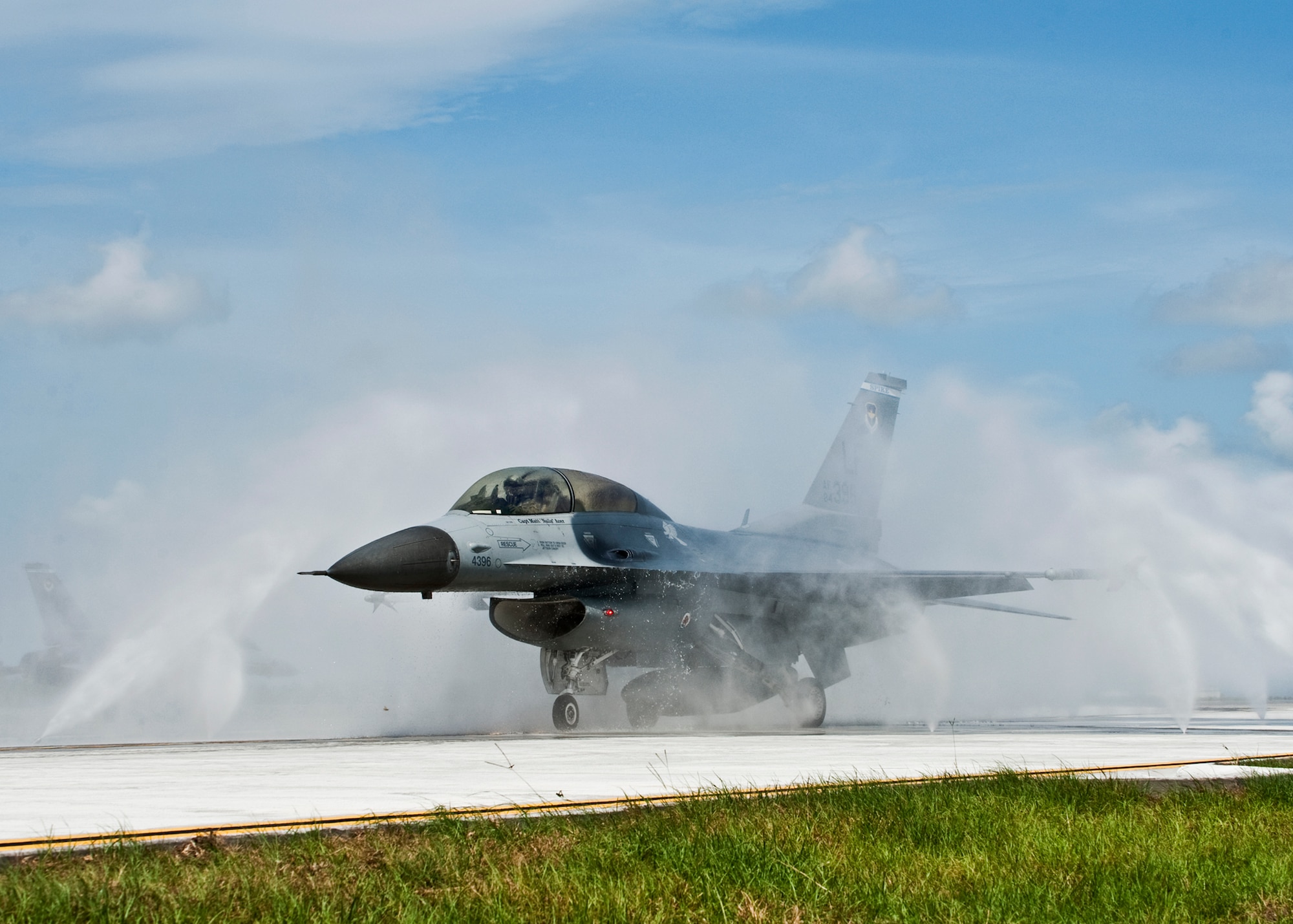An F-16 gets a “bath” from the newly installed fresh water rinse facility June 22 at Eglin Air Force Base, Fla.  The new 33rd Fighter Wing water system will be used to rinse off salt water deposits from the F-35 Joint Strike Fighter after a flight over the Gulf of Mexico.  According to the Federal Aviation Administration, rinsing the aircraft ensures the longevity of the metal components, costs less in maintenance and repair and uses less personnel time and effort to wash.  (U.S. Air Force photo/Samuel King Jr.)